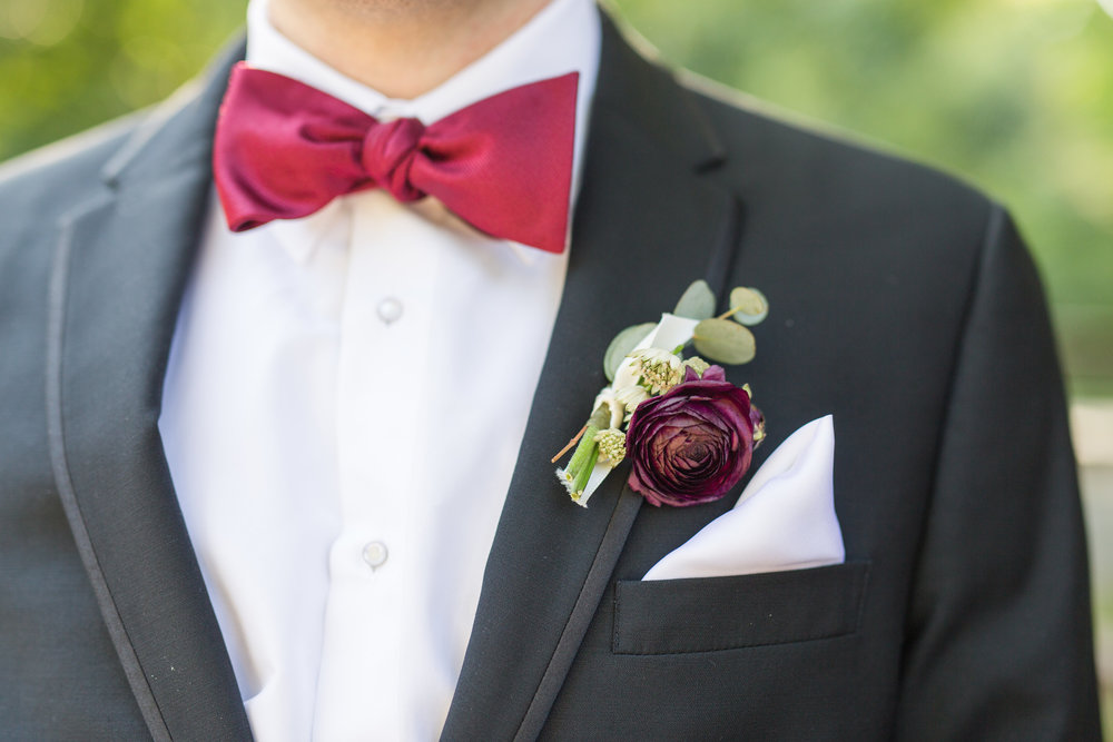 Beatufiul Ranunculus bloom boutonniere with eucalyptus