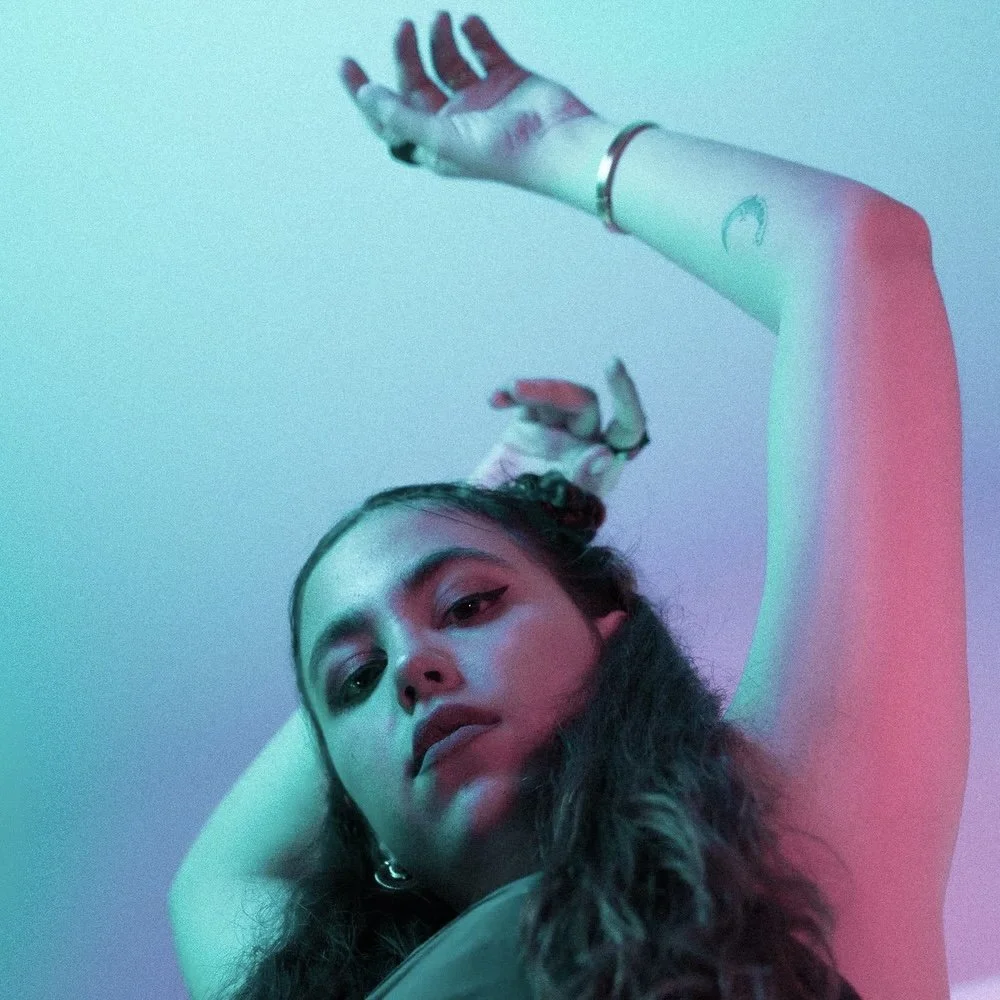 Rojaz alternative pop artist singing sad songs and emotional ballads in the style of Billie Eilish, Clairo, and Phoebe Bridgers.