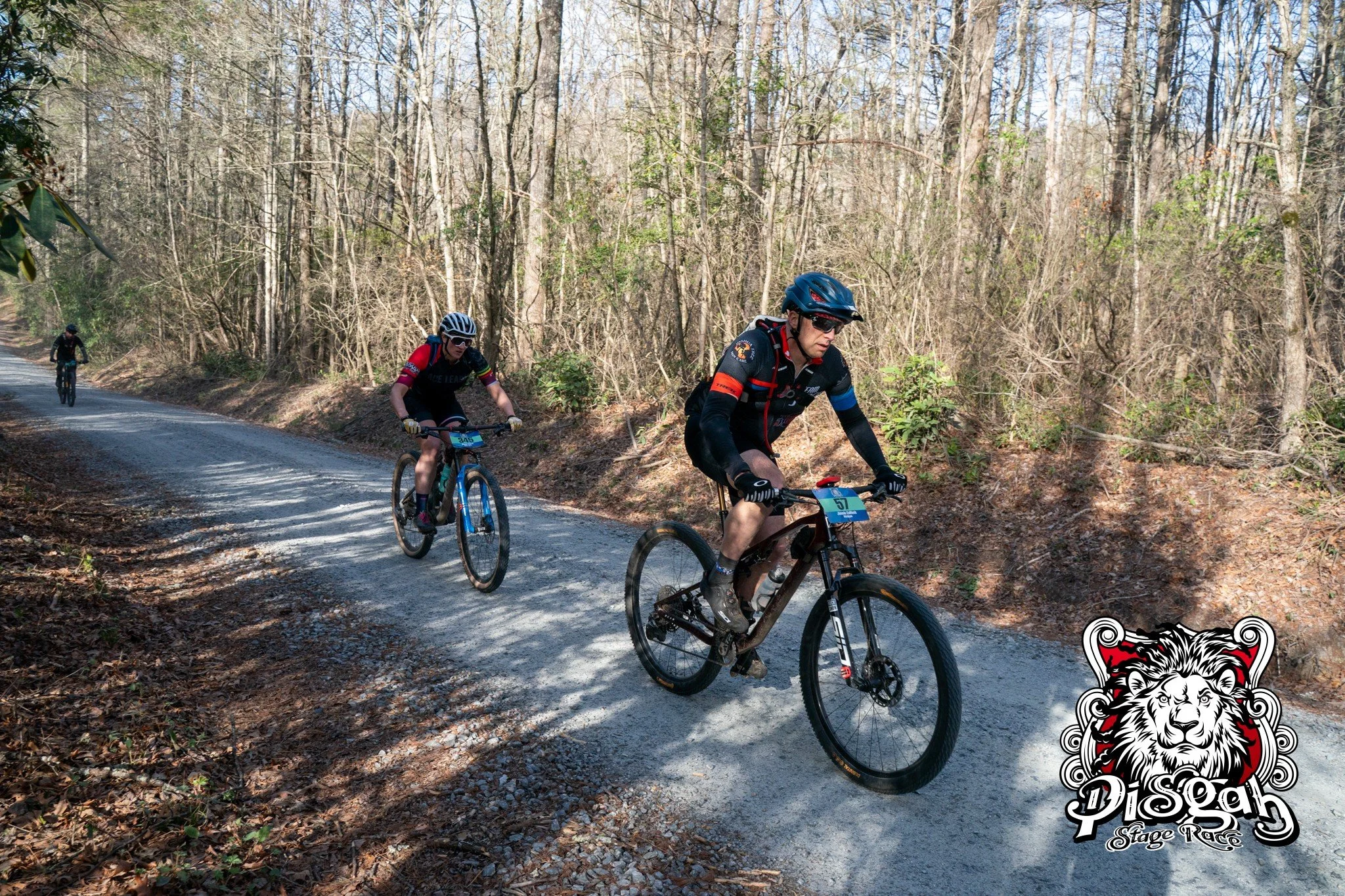 two racers struggle up a gravel climb