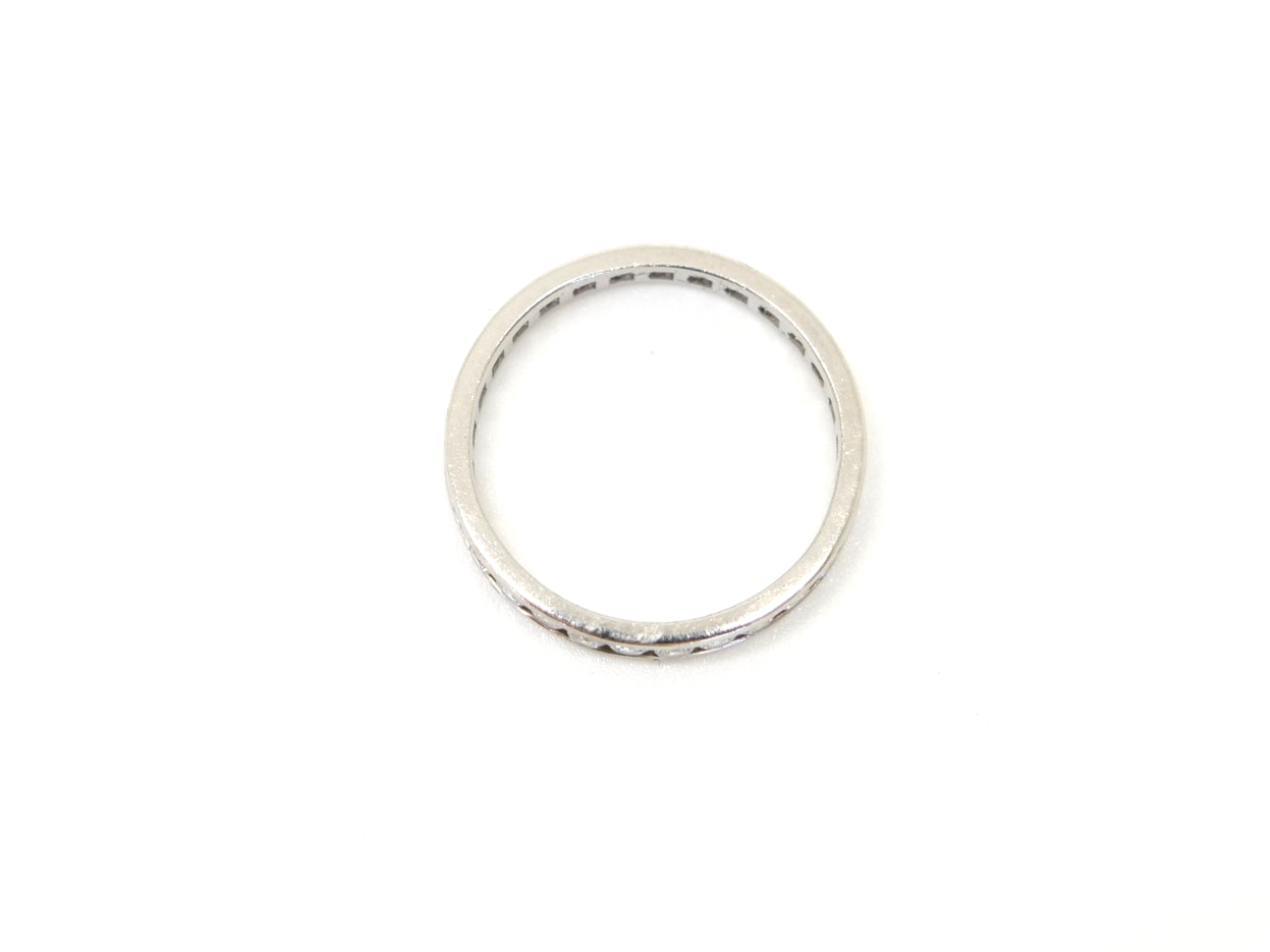 Contemporary platinum diamond full eternity ring, set with approximately 1ct brilliant cut diamonds.