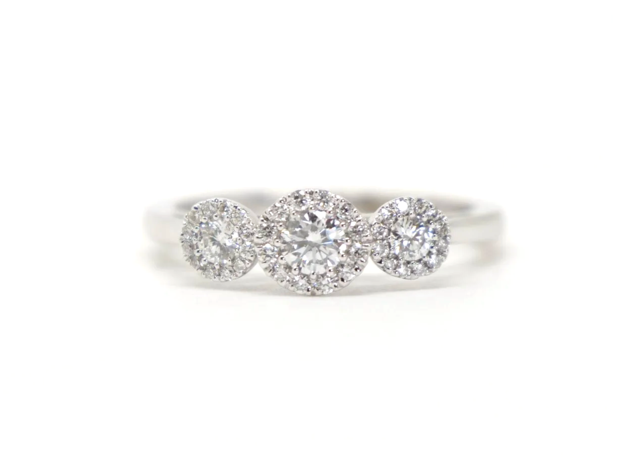 Contemporary 18ct gold diamond ring in a very pretty triple halo three stone design. Approximately 0.5cts diamonds total.