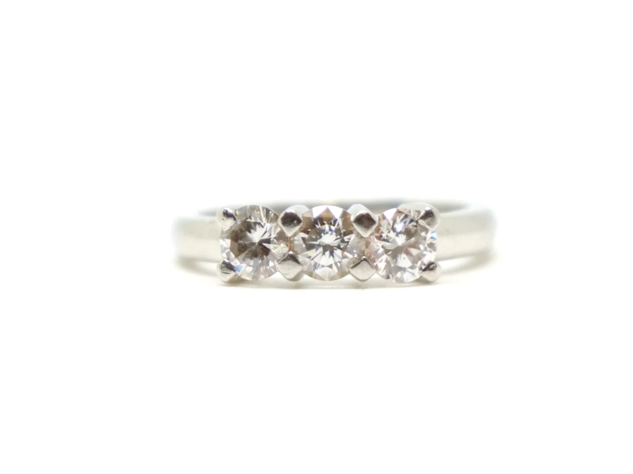 Platinum three stone 1ct diamond ring, three round brilliant cut diamonds in claw settings, hallmarked 2005, UK size K½