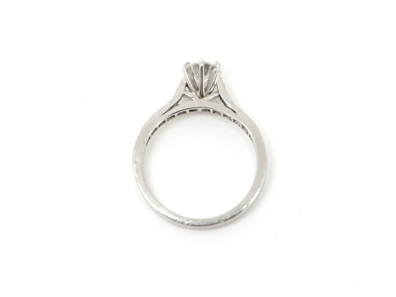 Super platinum gold diamond solitaire ring, set with a central brilliant cut diamond of approximately 0.55cts, with further brilliant cut diamonds set into each shoulder.
