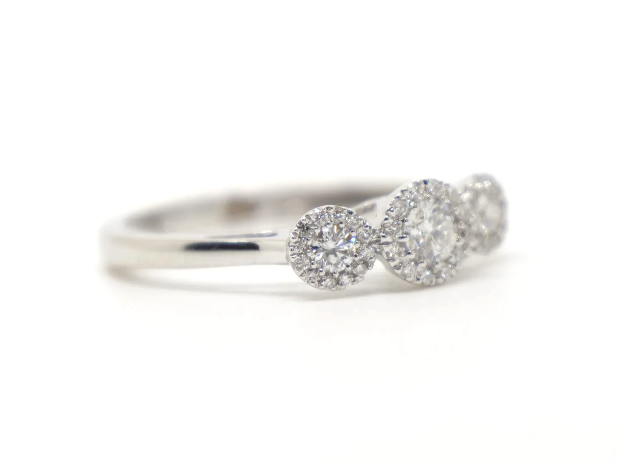 Contemporary 18ct gold diamond ring in a very pretty triple halo three stone design. Approximately 0.5cts diamonds total.