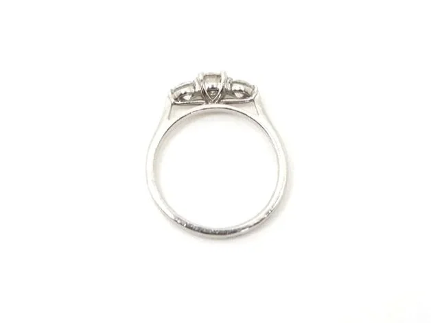 Stunning platinum diamond three stone ring, set with a central brilliant cut diamond of approximately 0.5cts, with a diamond on each shoulder of approximately 0.25cts each.