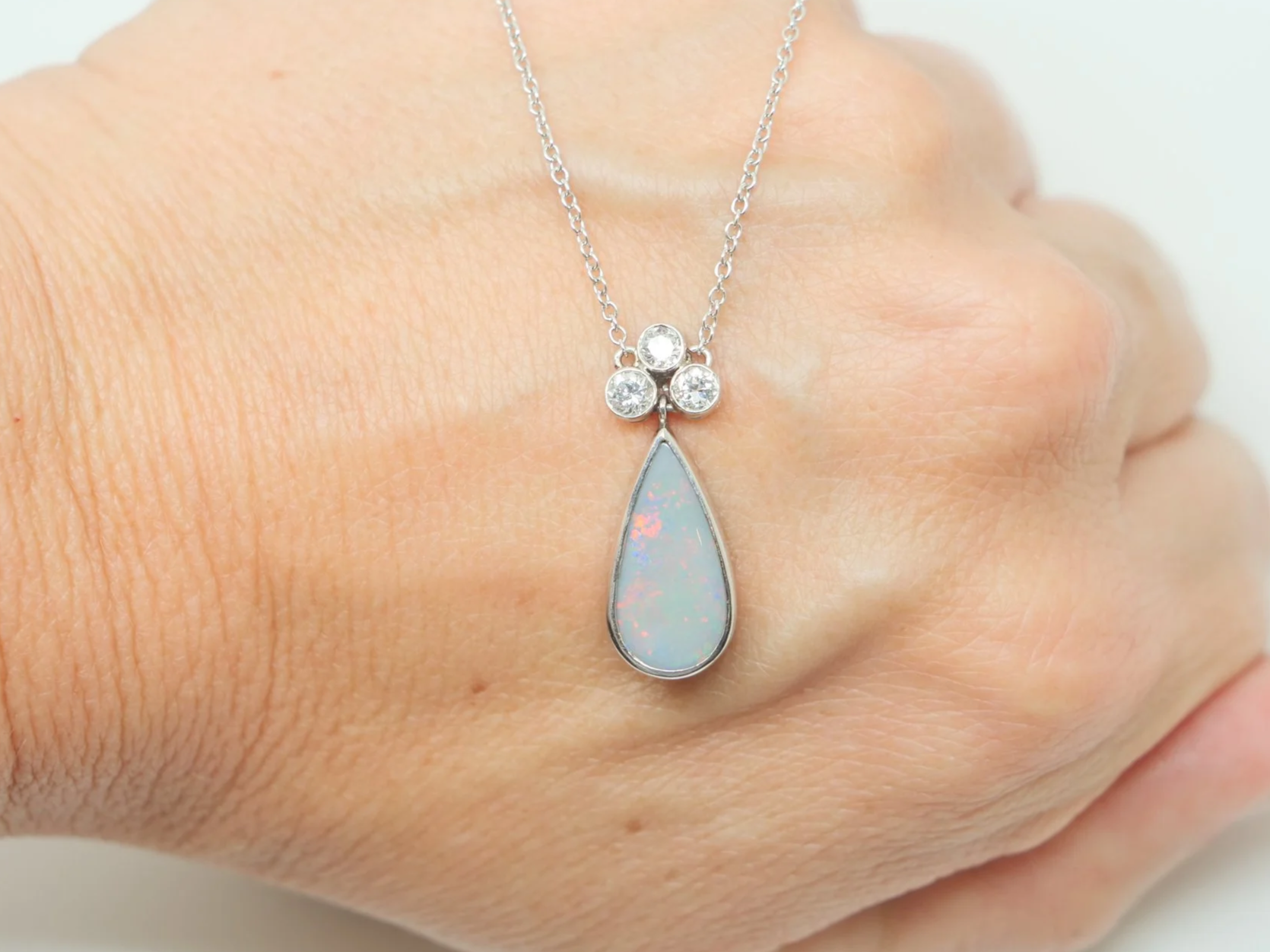 Stunning vintage 18ct gold black opal and old cut diamond pendant necklace, with a pear cut black opal and three old cut diamonds, with a 9ct gold chain.