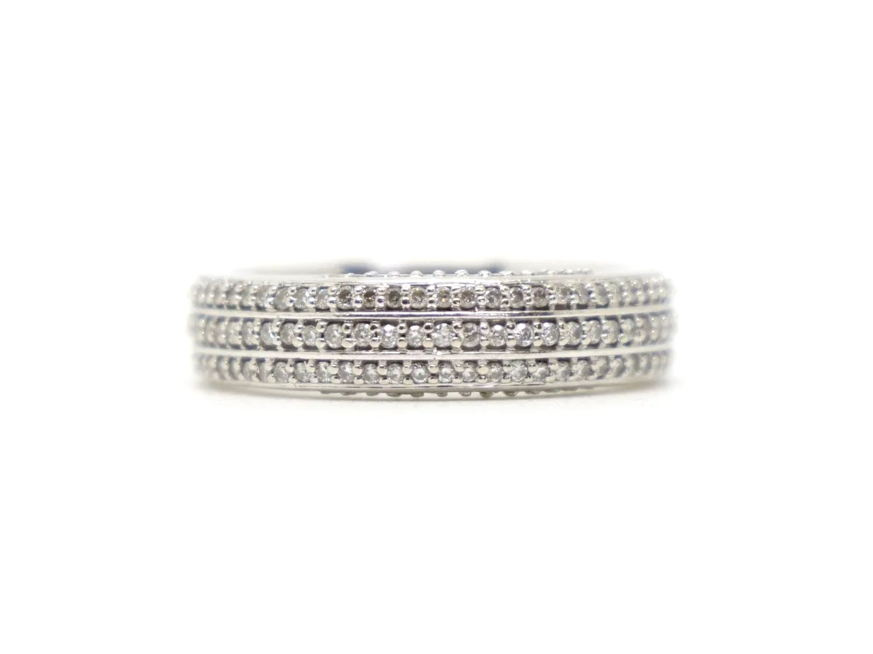 Contemporary 18ct gold triple row diamond three quarter eternity ring, with three rows of diamonds and further diamonds in both top and bottom of setting.
