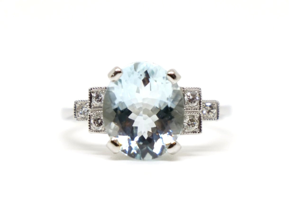 Super platinum Art Deco style aquamarine and diamond ring, set with a central oval cut aquamarine of approximately 3cts, with diamonds set in a step design into each shoulder.
