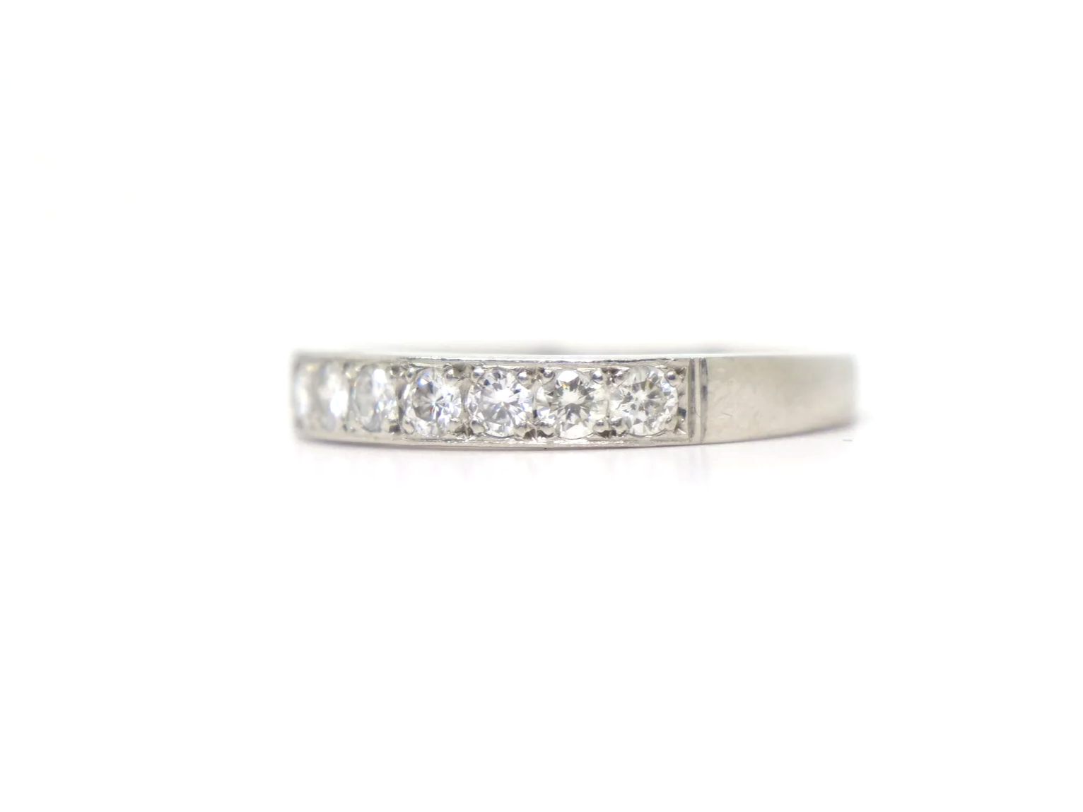 platinum diamond half-eternity ring set with seven round brilliant-cut diamonds