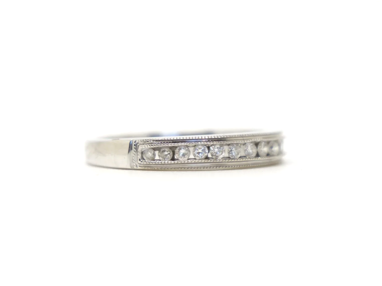 Beautiful 18ct white gold diamond half eternity ring, channel set with a row of brilliant cut diamonds across the front of the band, totalling 0.25ct.