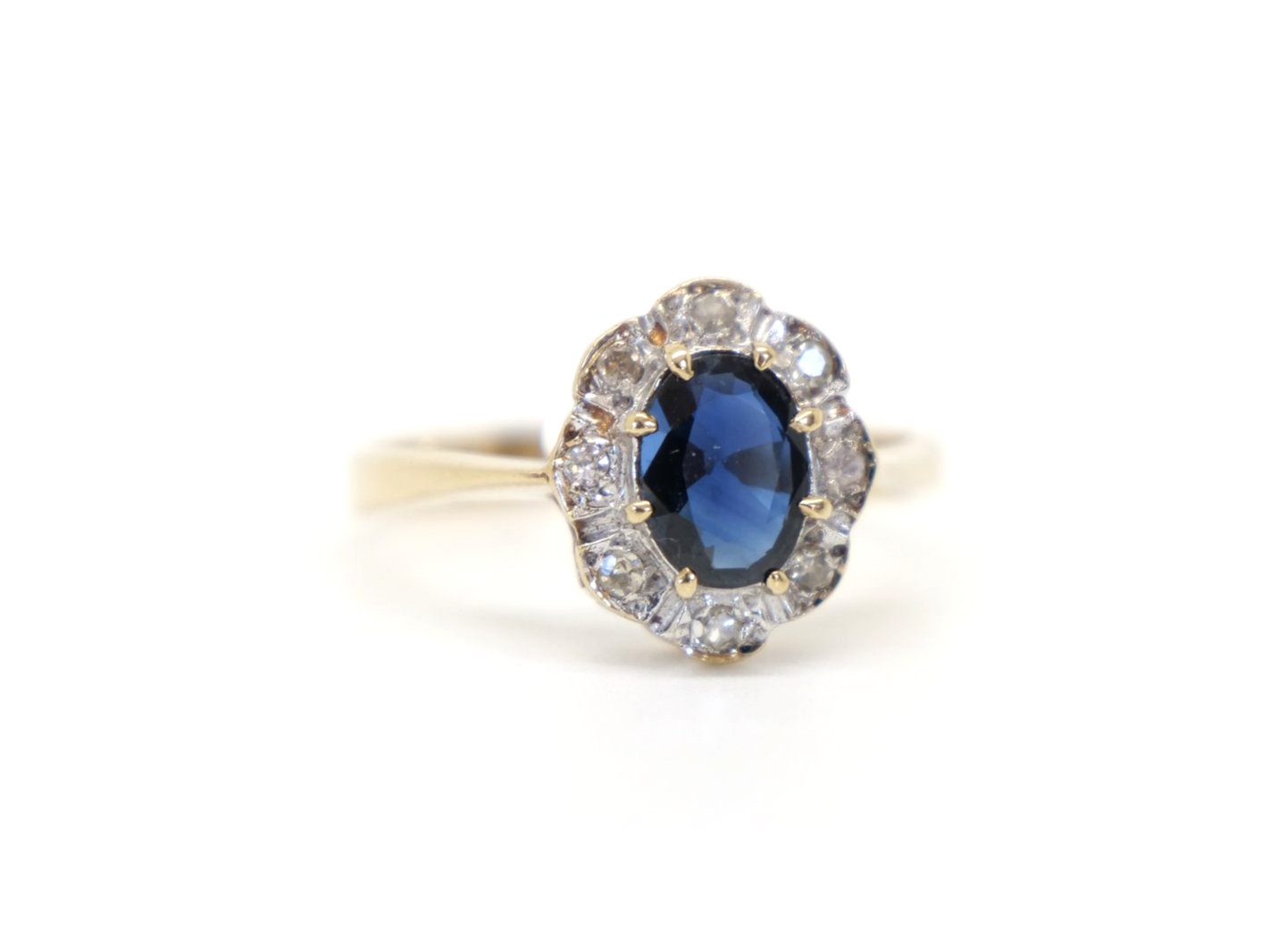 Very pretty vintage sapphire and diamond ring, set with a central oval cut sapphire of approximately 1ct and surrounded by small diamonds.