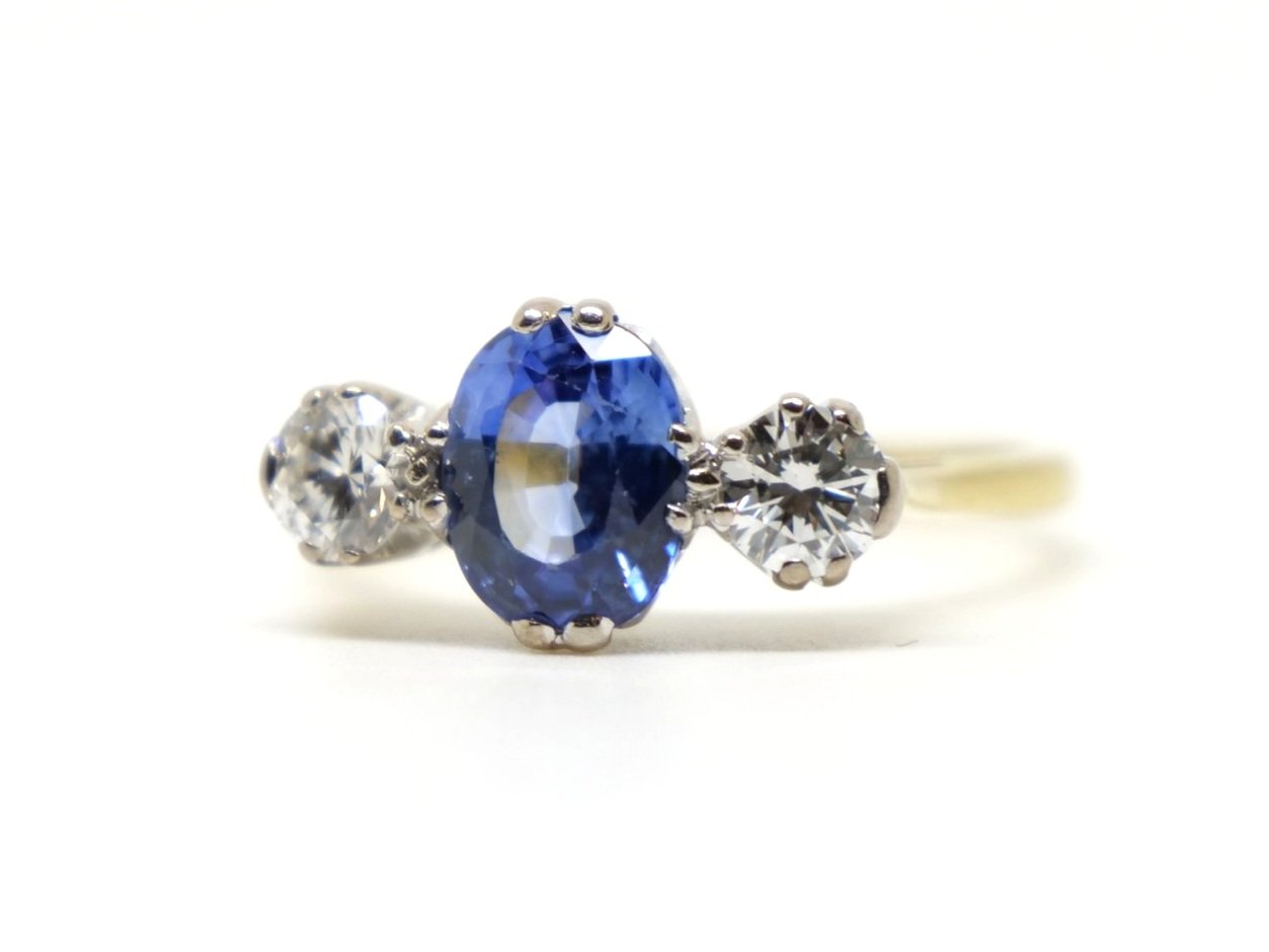 Stunning vintage 18ct gold sapphire and diamond ring, set with an oval cut sapphire with a diamond to each side.