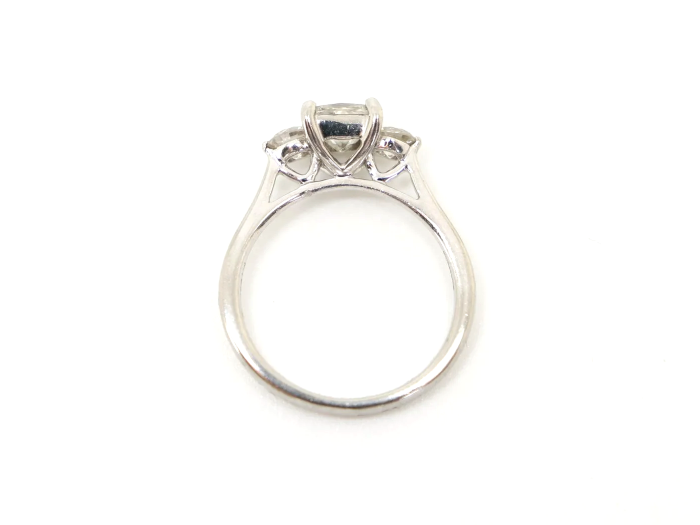 Super platinum diamond ring, set with a super princess cut centre diamond, with a brilliant cut diamond to each side.