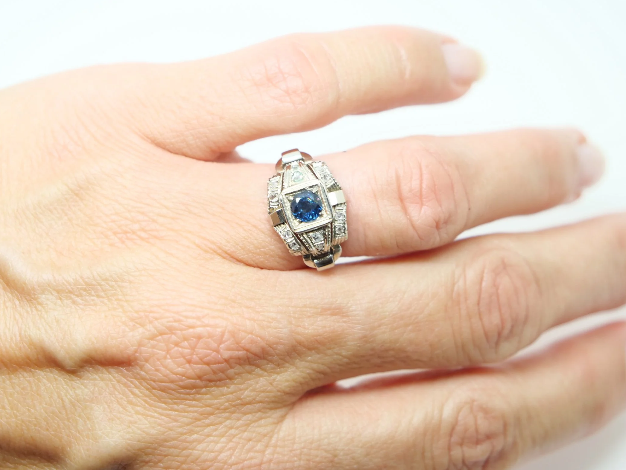 Unusual French Art Deco 18ct gold sapphire and old cut diamond ring, set with a single round cut sapphire. Old cut diamonds set into the unusual design.