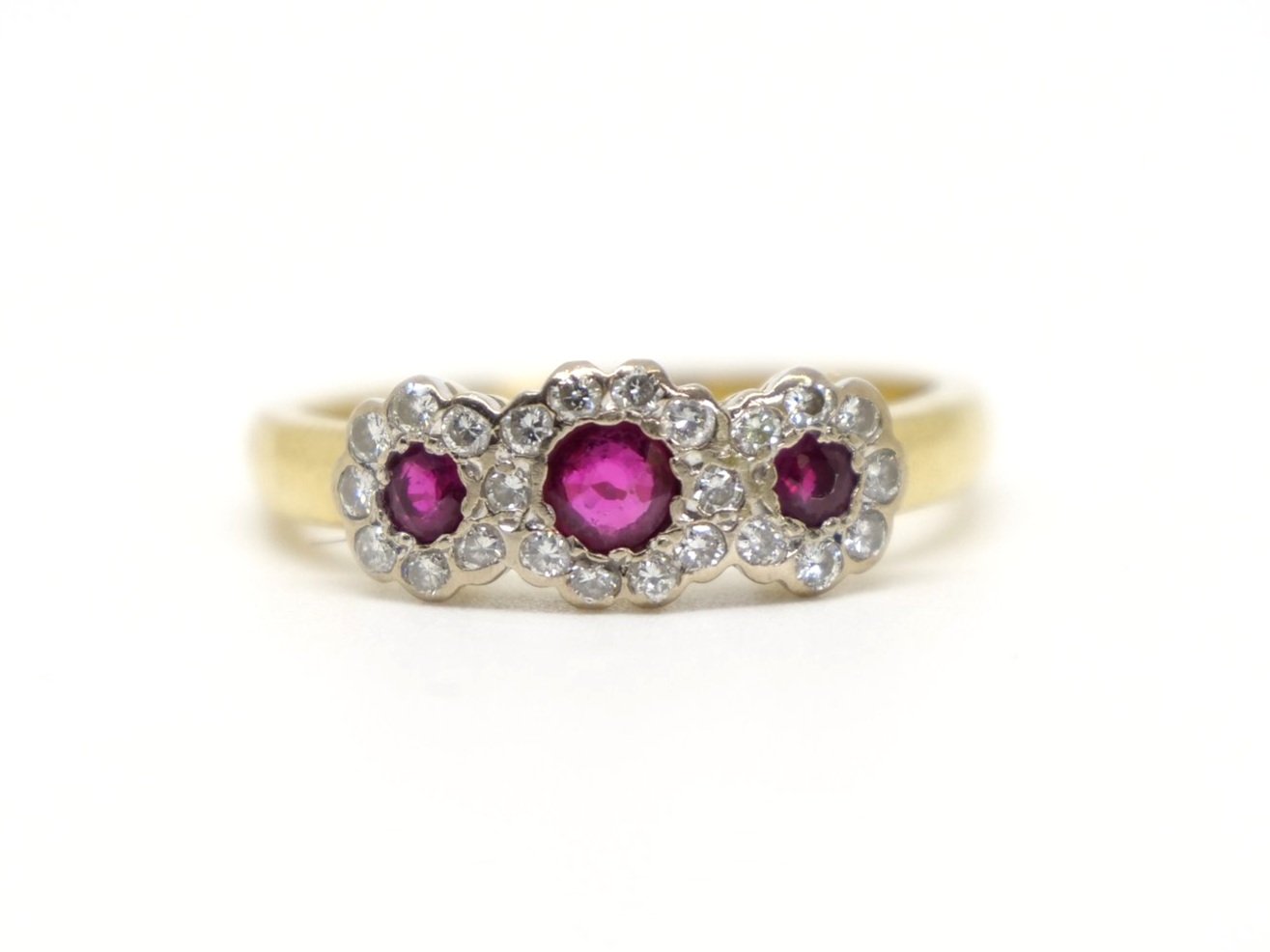 Very pretty 18ct gold ruby and diamond triple flower cluster ring, set with three round cut rubies with a diamond surround.