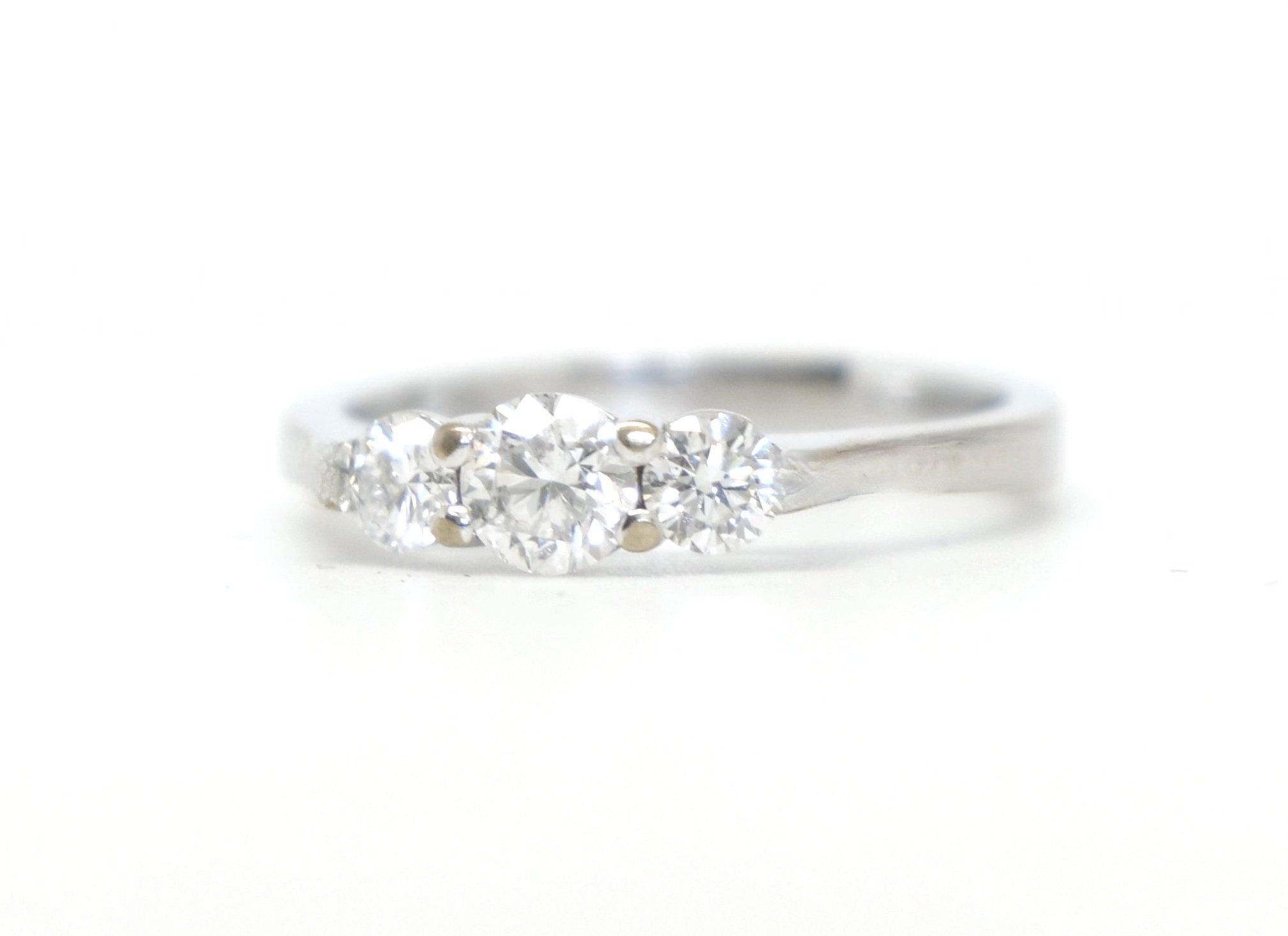 Stunning 18ct gold vintage diamond trilogy ring, set with three brilliant cut diamonds in an unusual elegant design. Approximately 0.7cts in total.