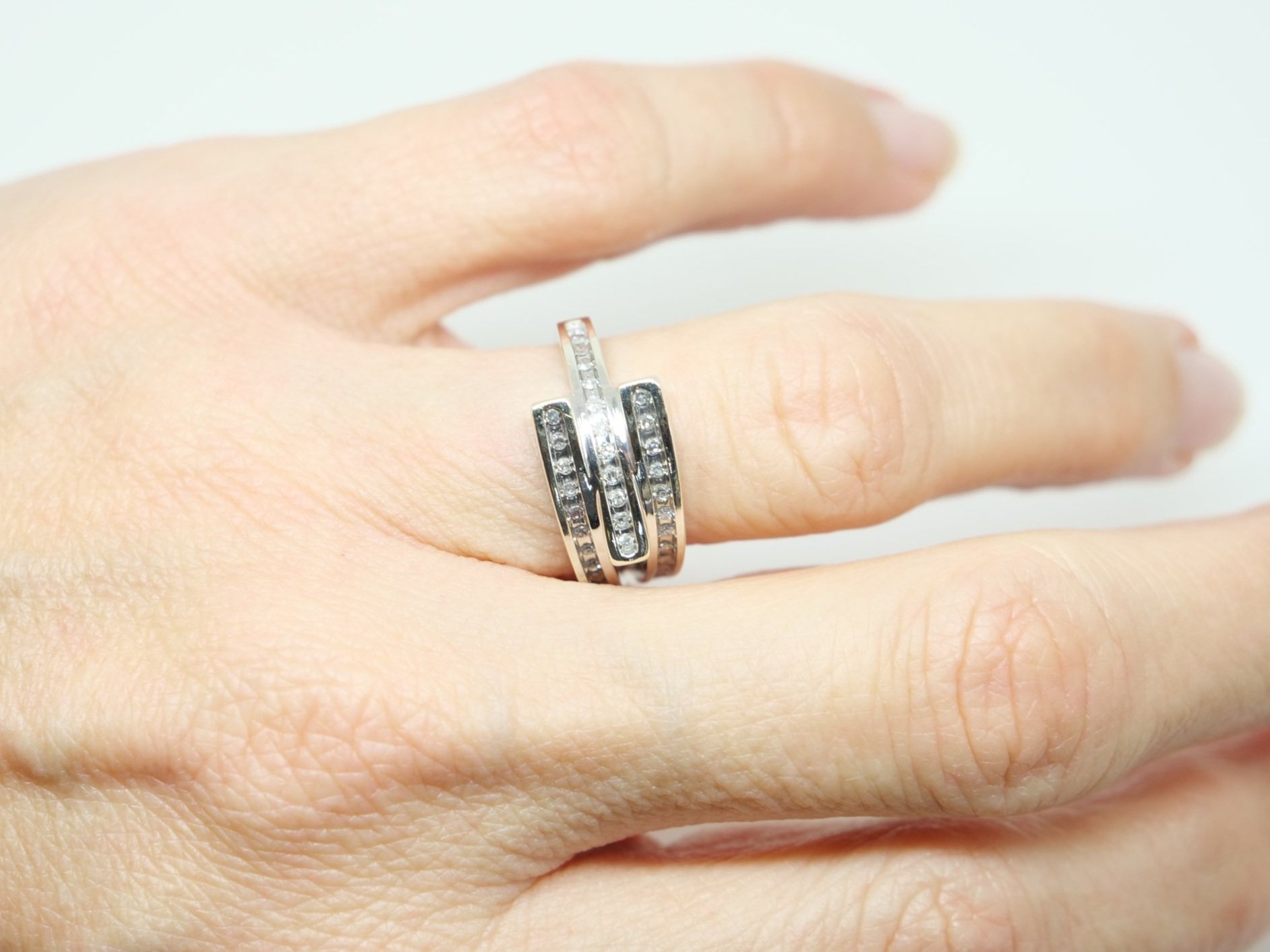 Contemporary 9ct gold chunky style diamond crossover ring, with three diamond set bands that cross over in this unusual design.