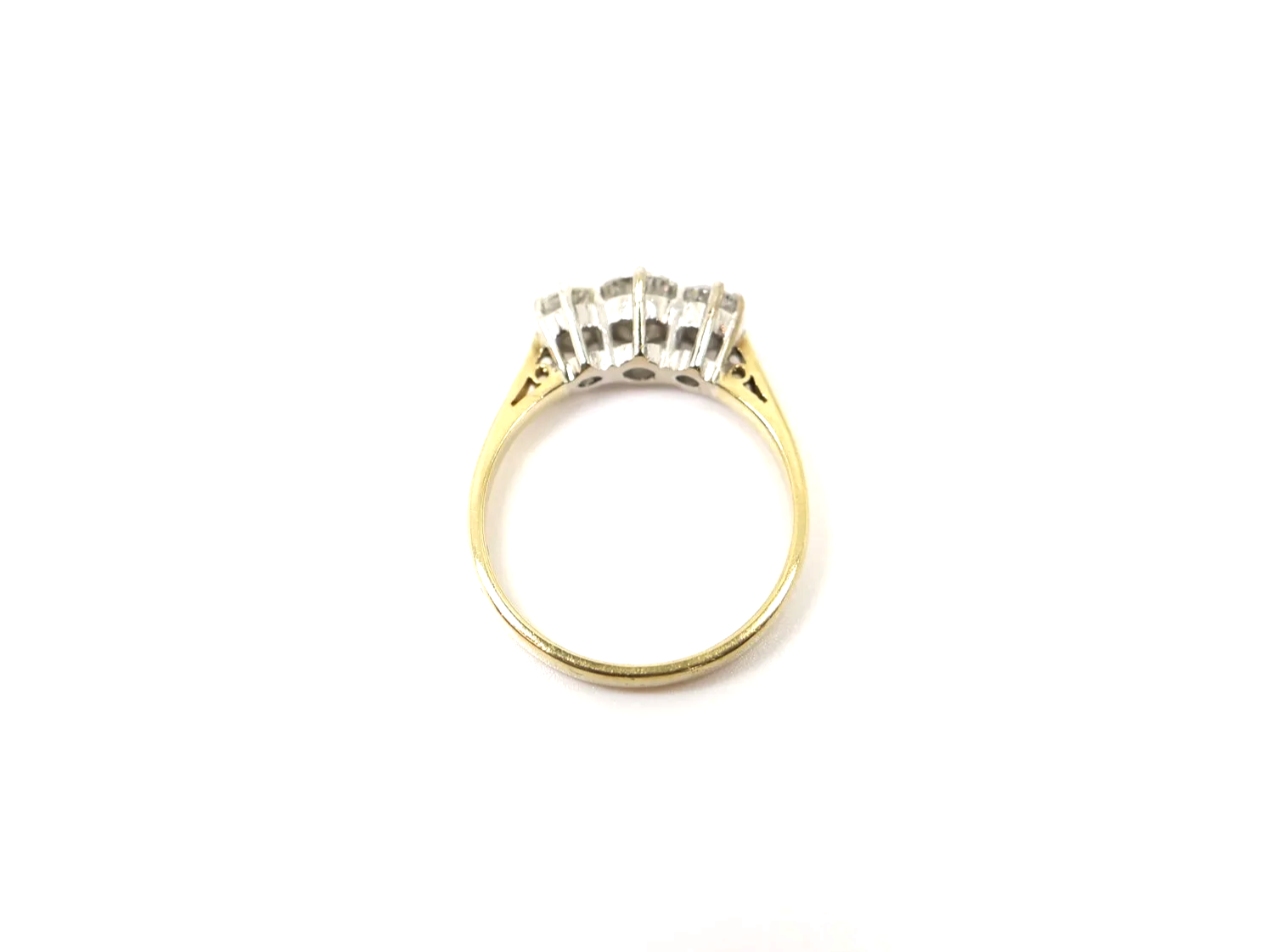 A classic 18ct gold diamond three stone ring from 1997, set with three round brilliant cut diamonds of approximately 1 carat in total.