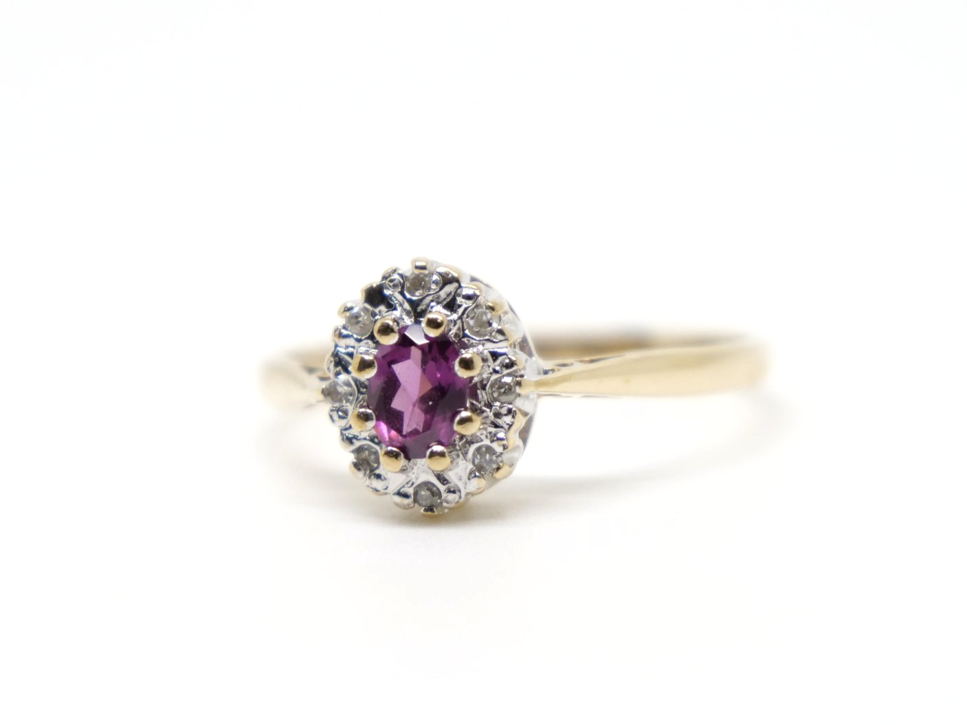 Pretty vintage 9ct gold pink tourmaline and diamond cluster ring, set with an oval cut pink tourmaline and surrounded by diamonds.