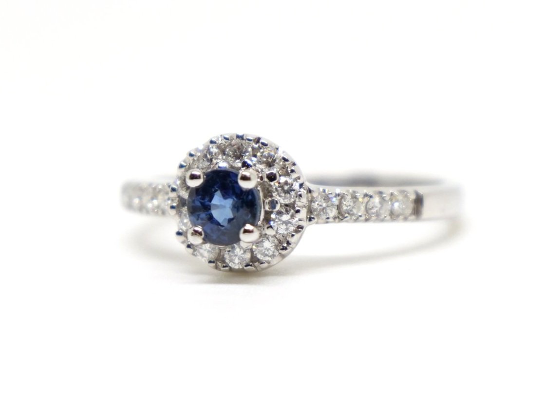 Very sparkly 18ct gold sapphire and diamond ring, set with a central round cut sapphire surrounded by diamonds. Further diamonds to each shoulder.
