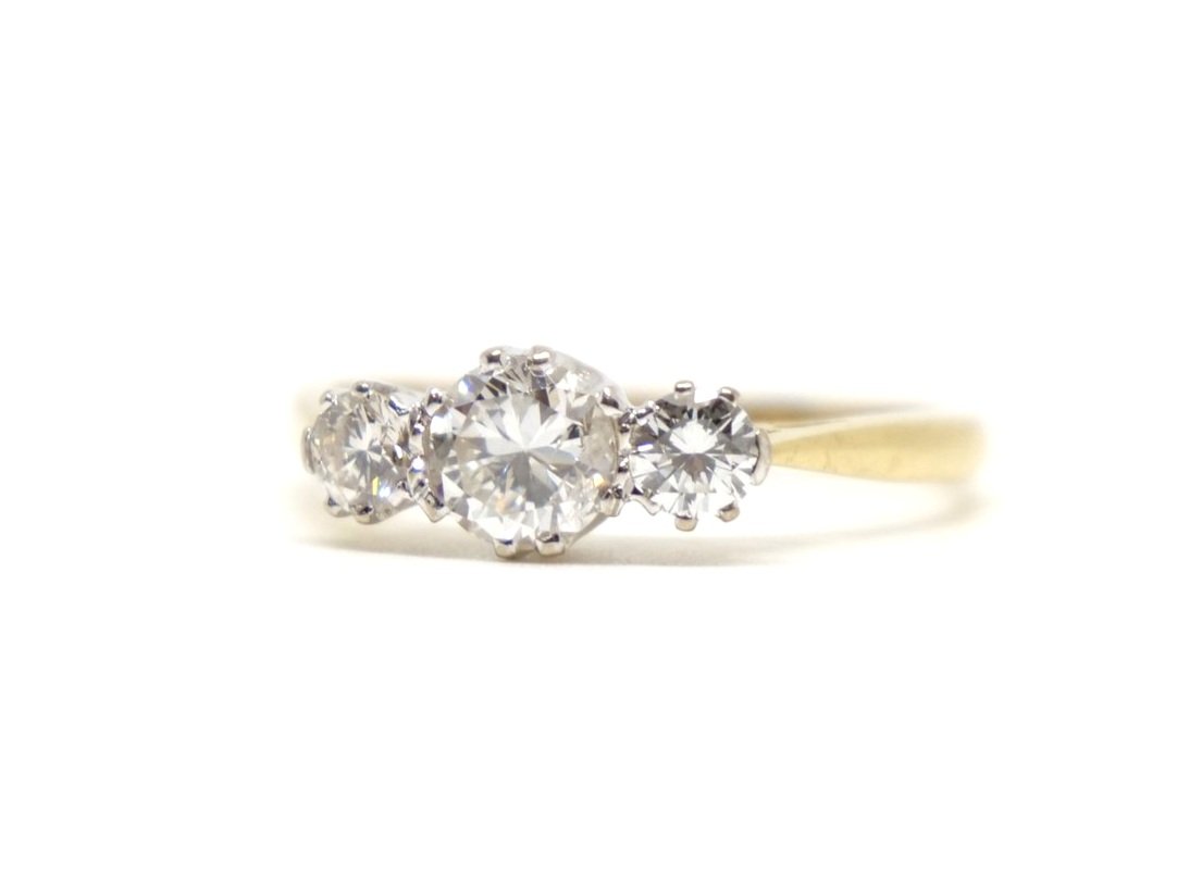 Super 18ct gold diamond trilogy ring, set with a central brilliant cut diamond of approximately 0.6cts, with a diamond to each side. Total diamond weight approximately 0.95ct.