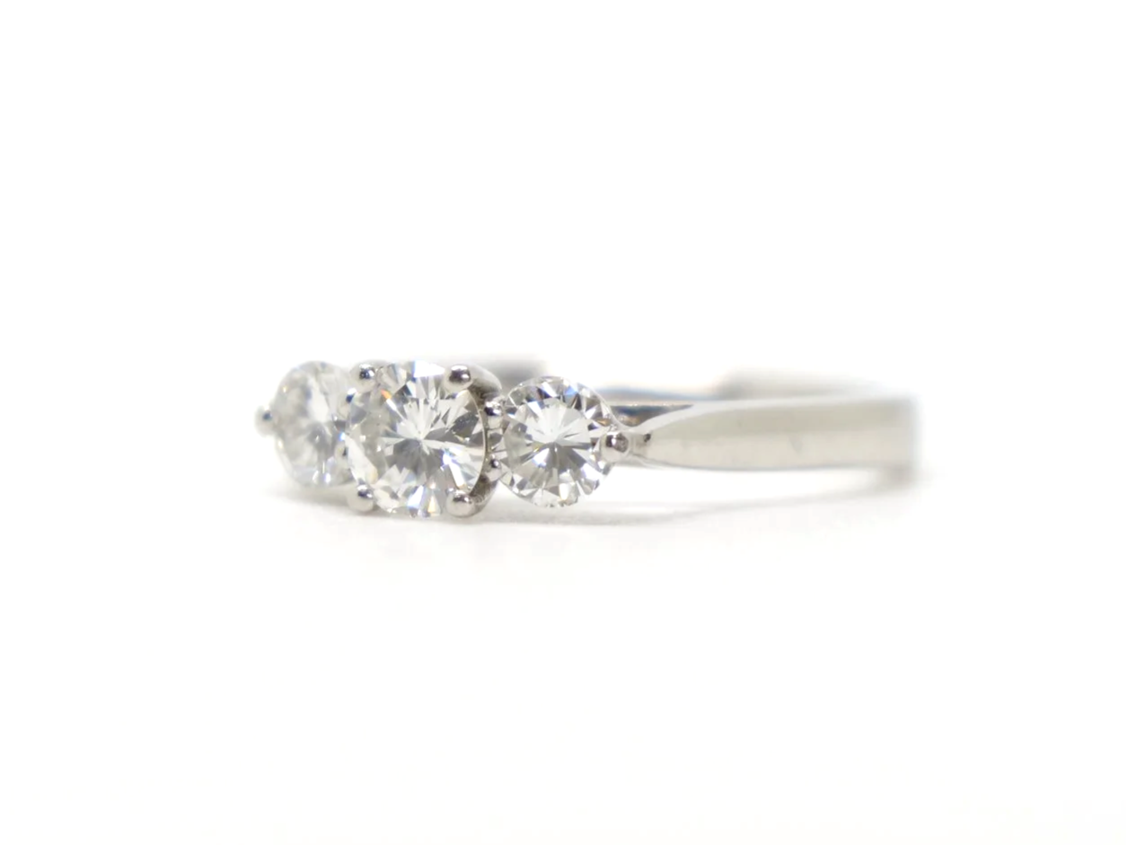Stunning platinum diamond three stone ring, set with a central brilliant cut diamond of approximately 0.5cts, with a diamond on each shoulder of approximately 0.25cts each.