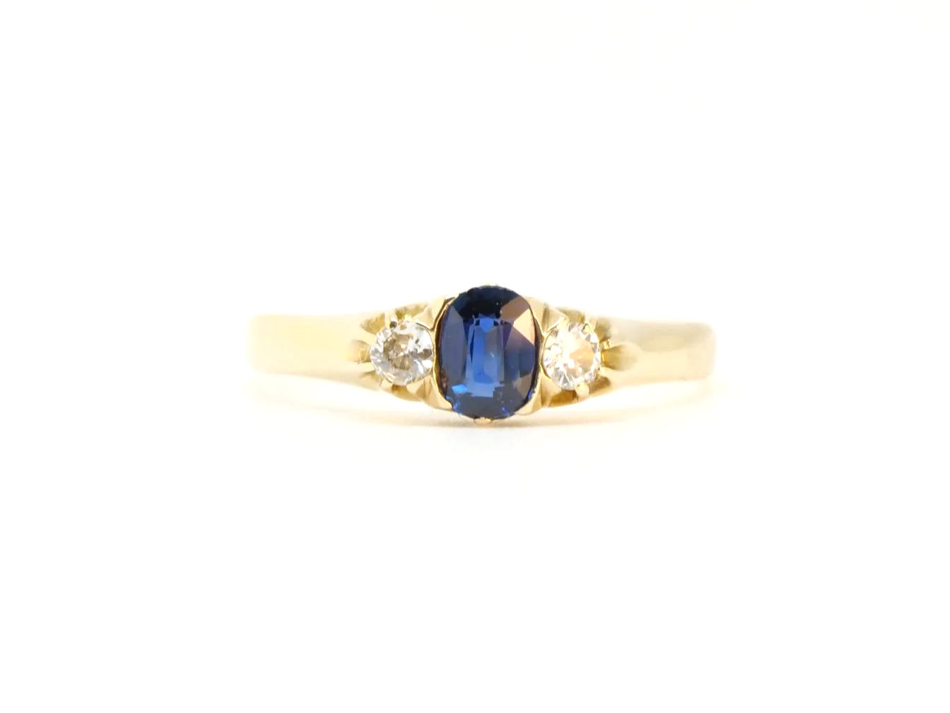 Vintage 18ct gold sapphire and diamond trilogy ring, set with a lovely blue sapphire with an old cut diamond to each side.