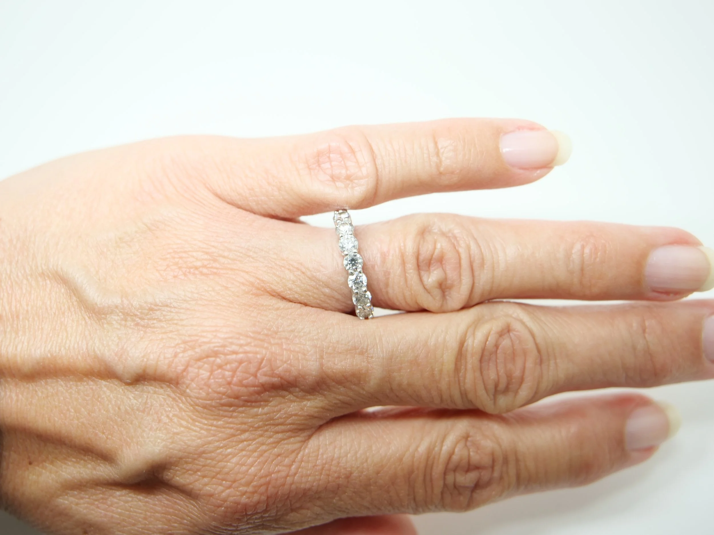 platinum diamond half-eternity ring set with seven round brilliant-cut diamonds
