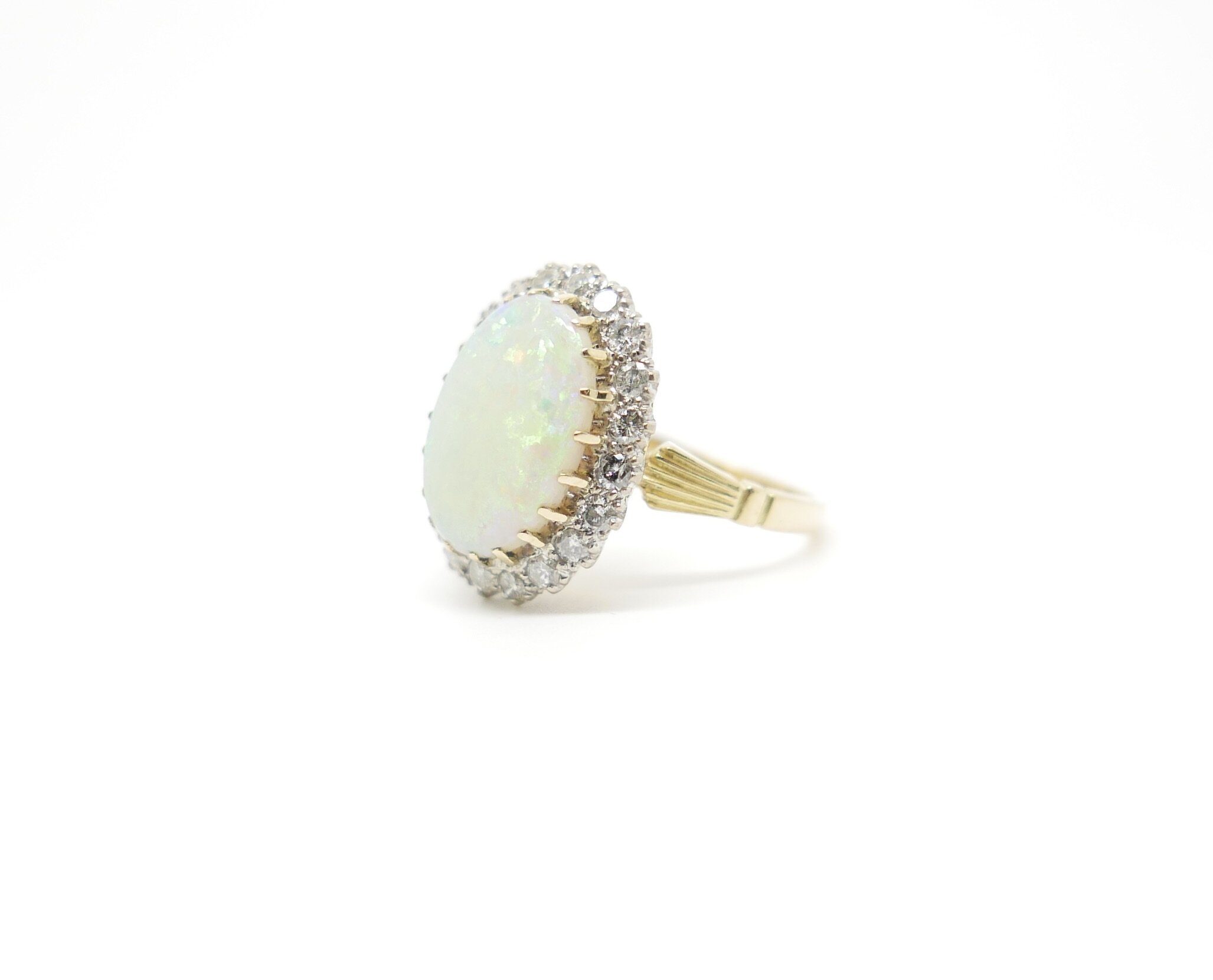 Vintage Ring set with large Opal and surrounded by twenty brilliant cut diamonds in 18ct gold | antique jewellery