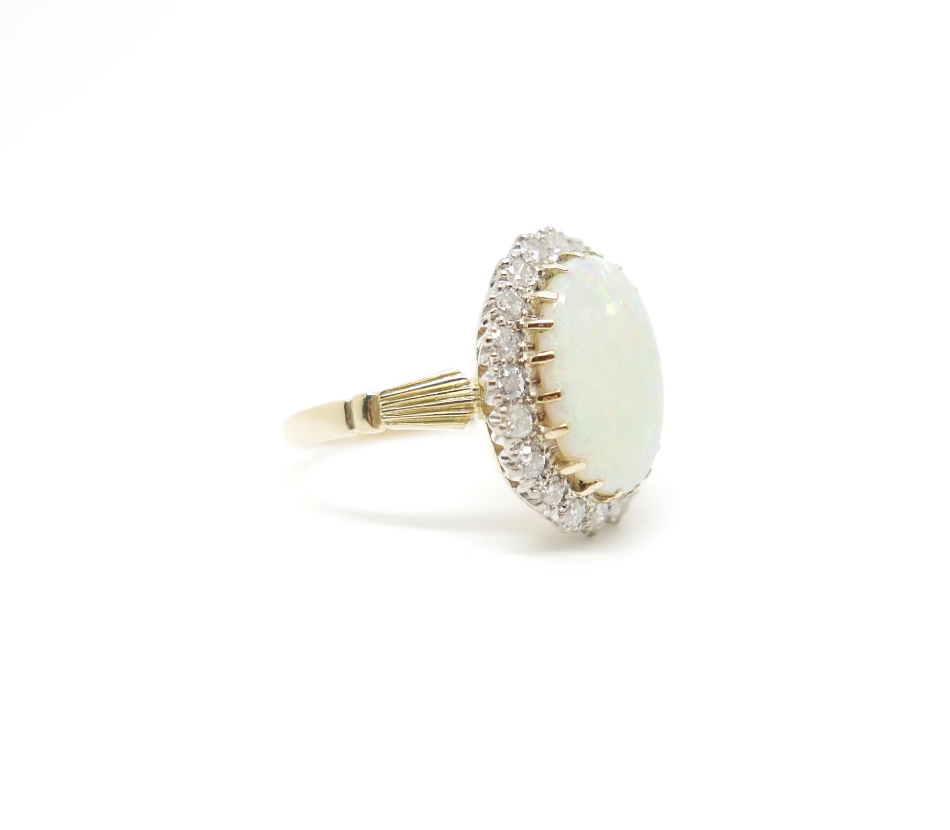 Vintage Ring set with large Opal and surrounded by twenty brilliant cut diamonds in 18ct gold | antique jewellery