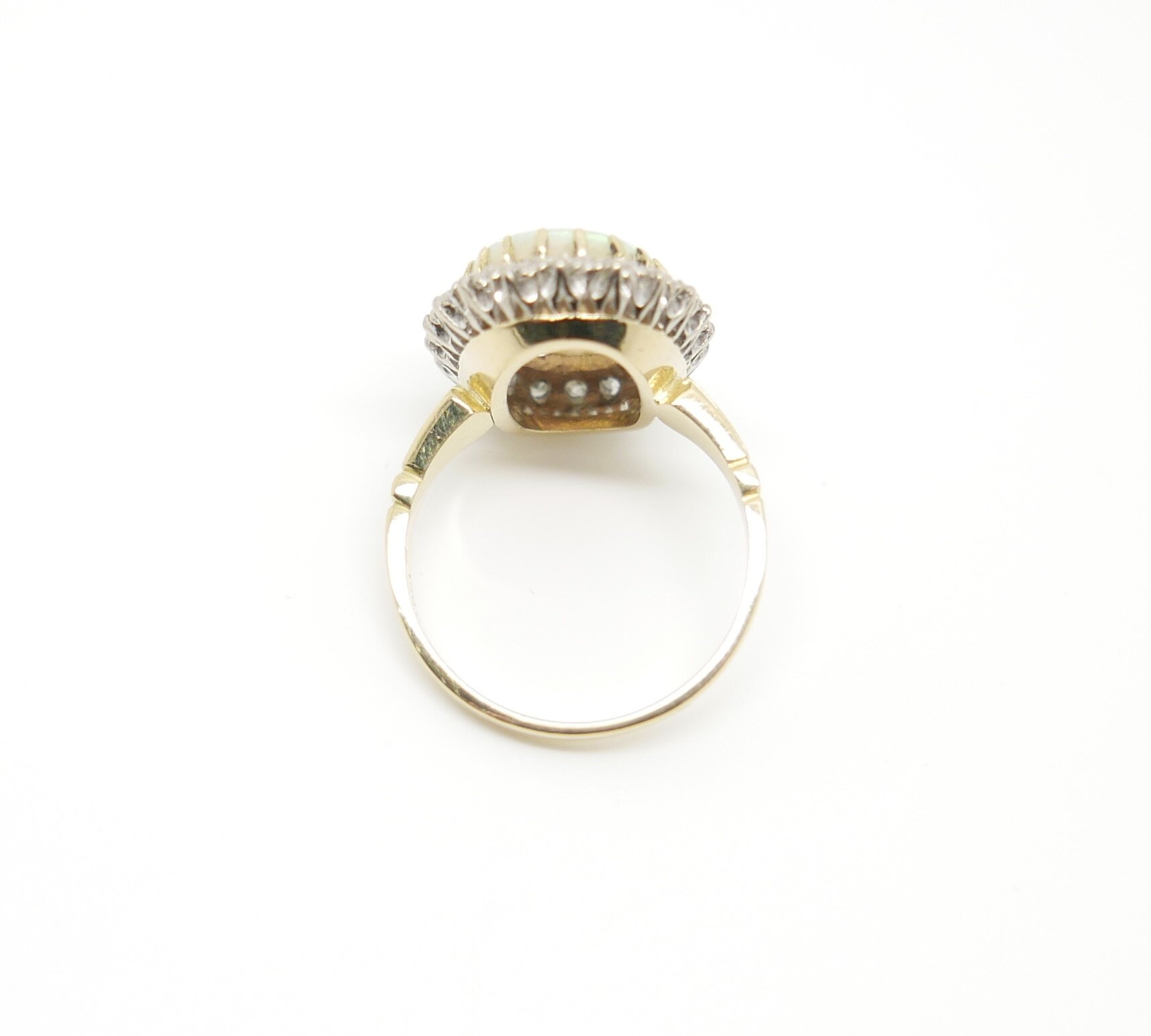 Vintage Ring set with large Opal and surrounded by twenty brilliant cut diamonds in 18ct gold.