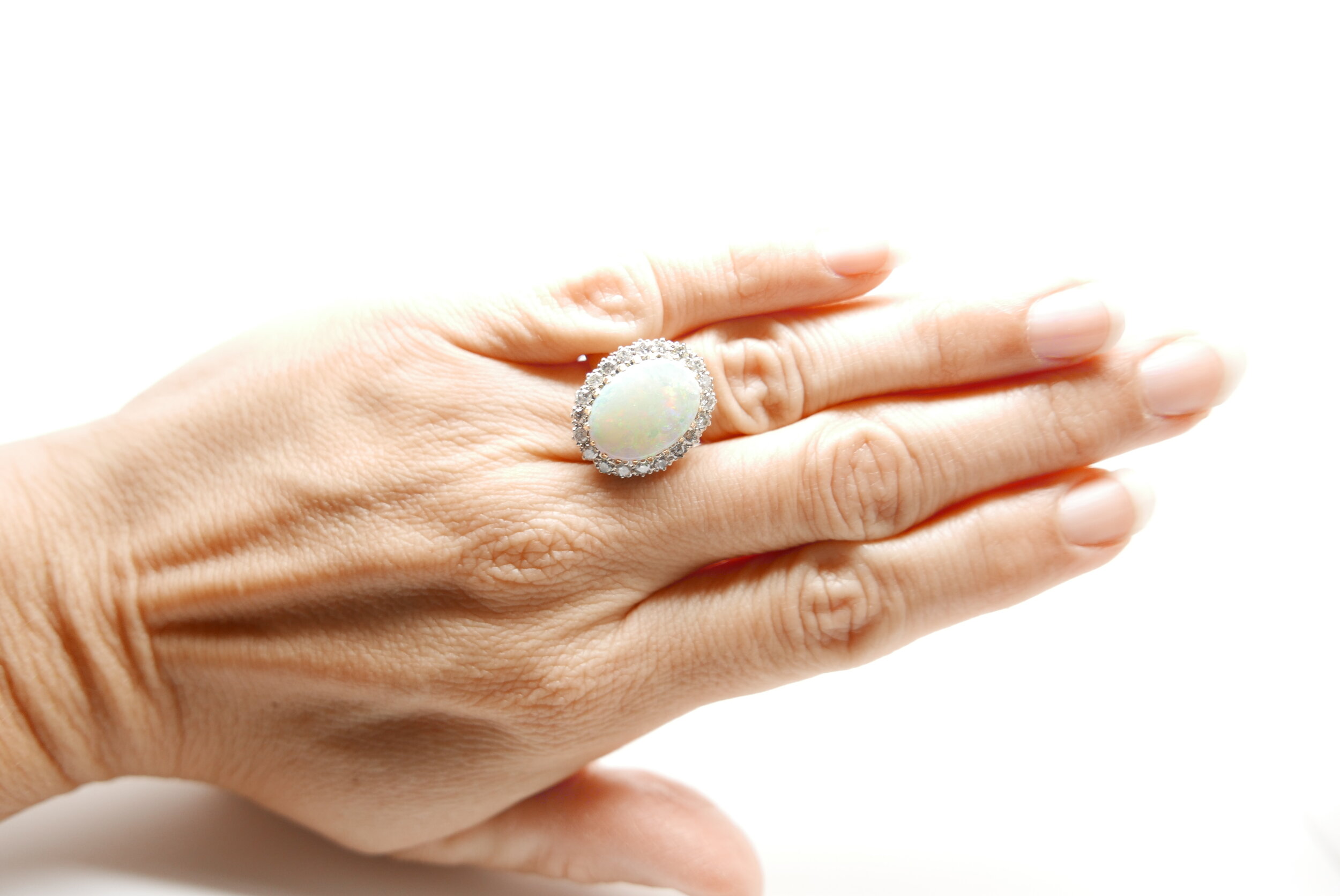 Vintage Ring set with large Opal and surrounded by twenty brilliant cut diamonds in 18ct gold.