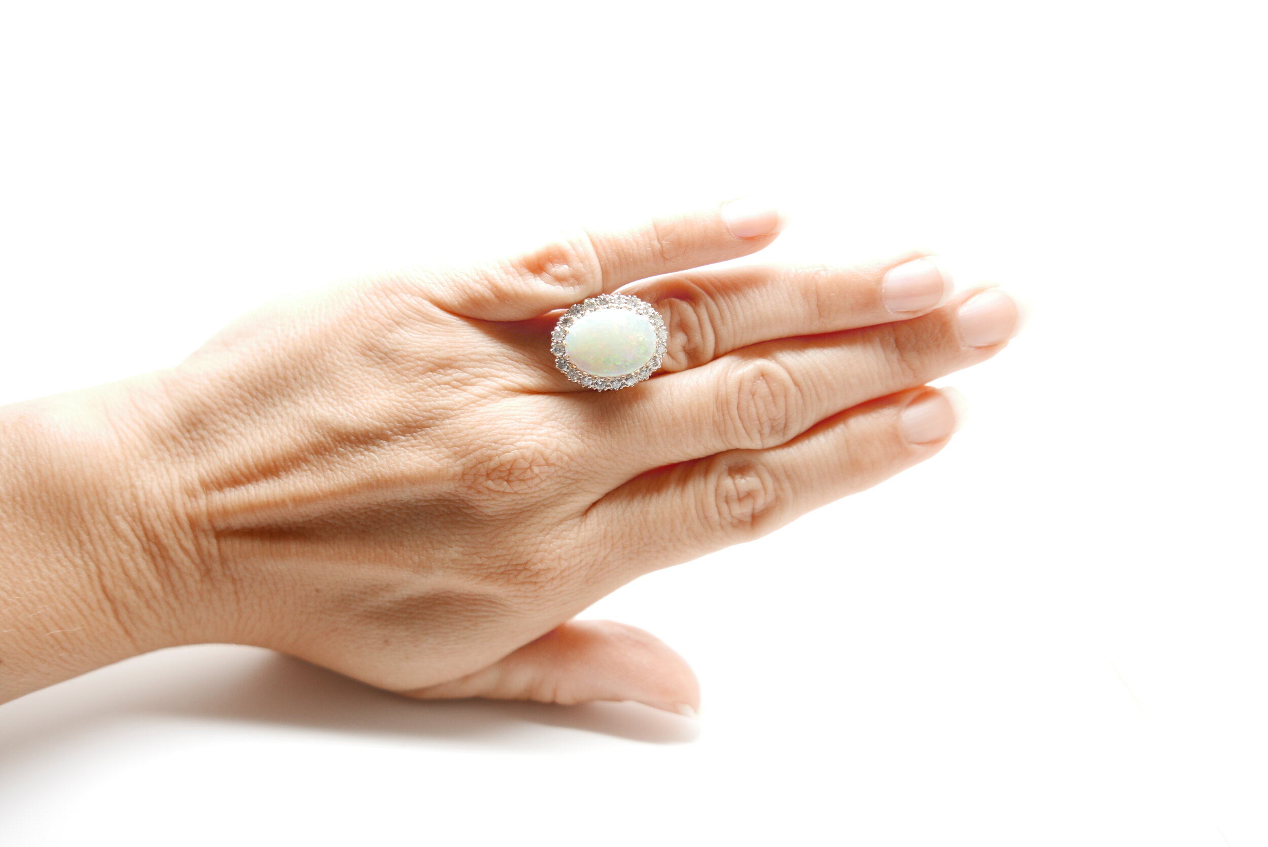 Vintage Ring set with large Opal and surrounded by twenty brilliant cut diamonds in 18ct gold.