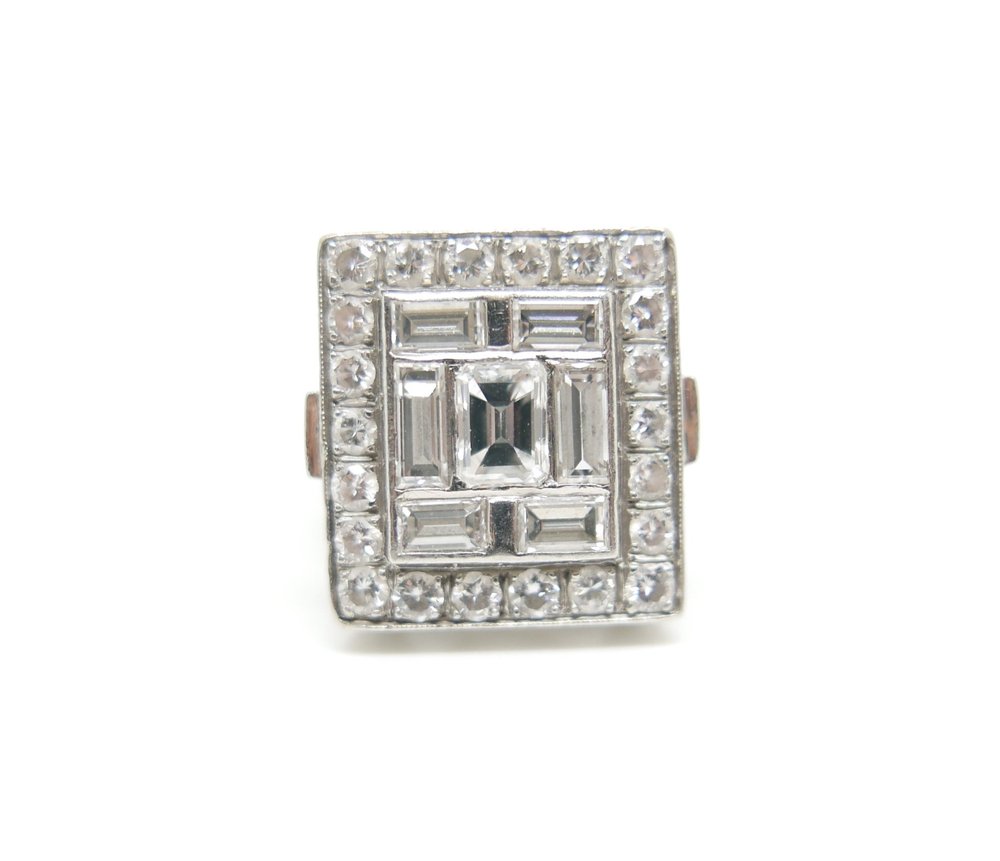 Outstanding later Art Deco ring, set with a mixture of brilliant cut and large baguette cut diamonds. Centre emerald cut diamond of approximately 0.65cts, with total diamond weight 2.75ct.