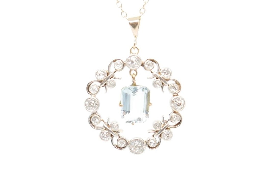 Art Deco aquamarine and diamond pendant, with diamond halo and central emerald cut aquamarine in platinum and 18ct gold.