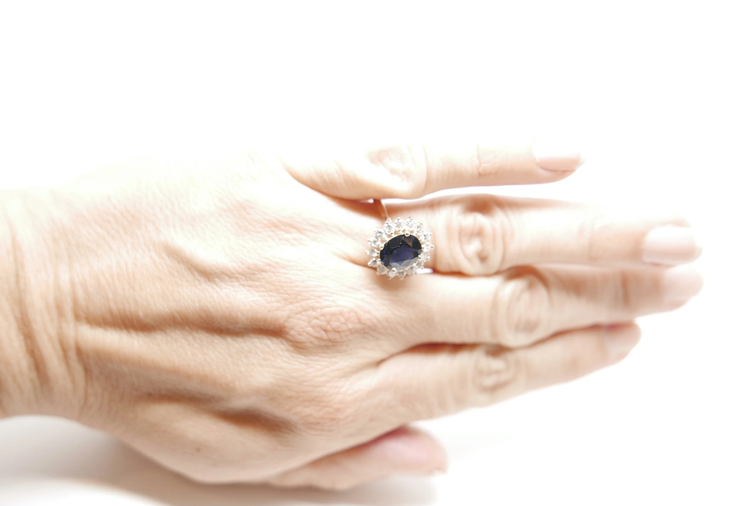 vintage sapphire and diamond cluster ring, set with a central oval cut sapphire of approximately 2.2 carats. Surrounded by brilliant cut diamonds,  approximately 0.48cts.