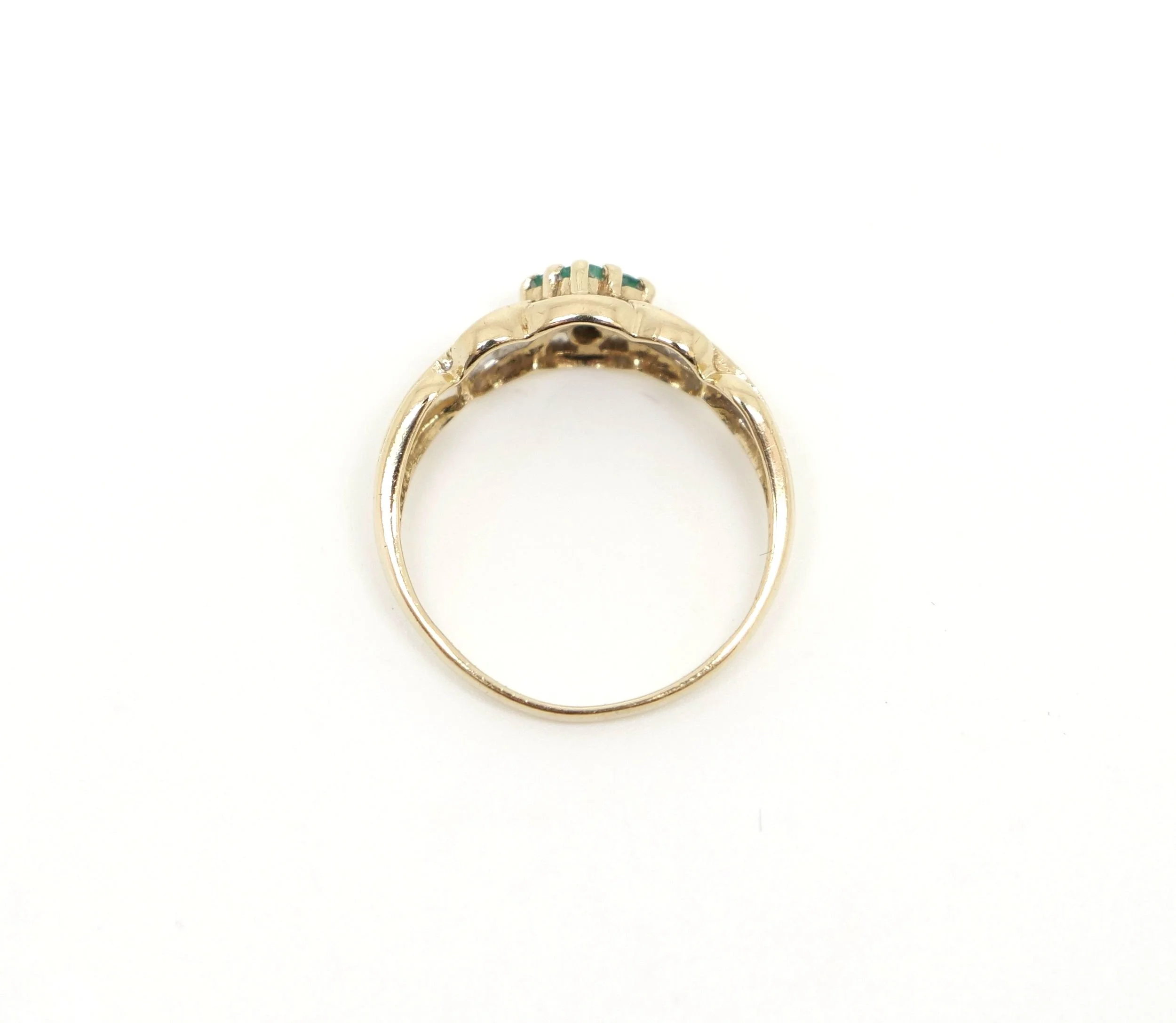 vintage ring, set with four small emeralds in the centre, with a tiny diamond to each shoulder. Very pretty crossover setting in 9ct gold