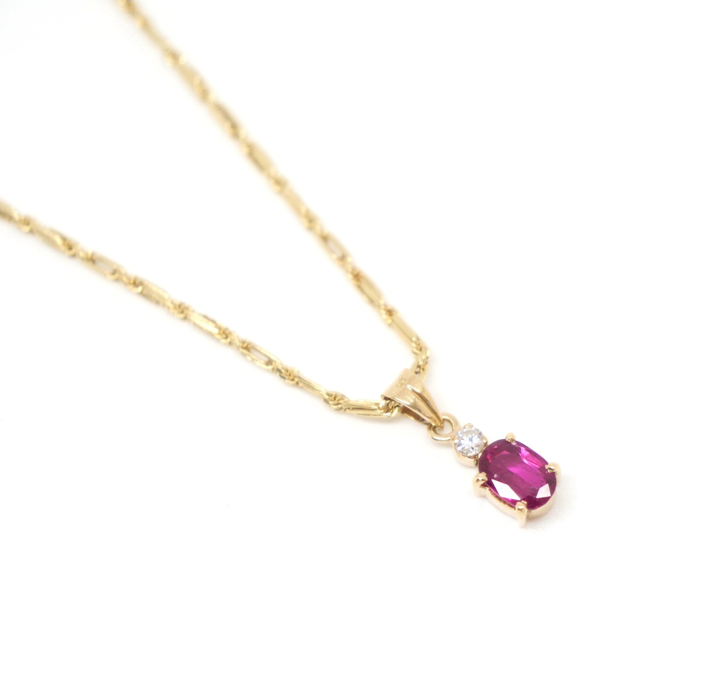 Lovely quality Italian ruby and diamond pendant, set in 14ct gold. Oval cut ruby approximately 0.9ct with extremely sparkly diamond above. Comes with 14ct chain from the USA.