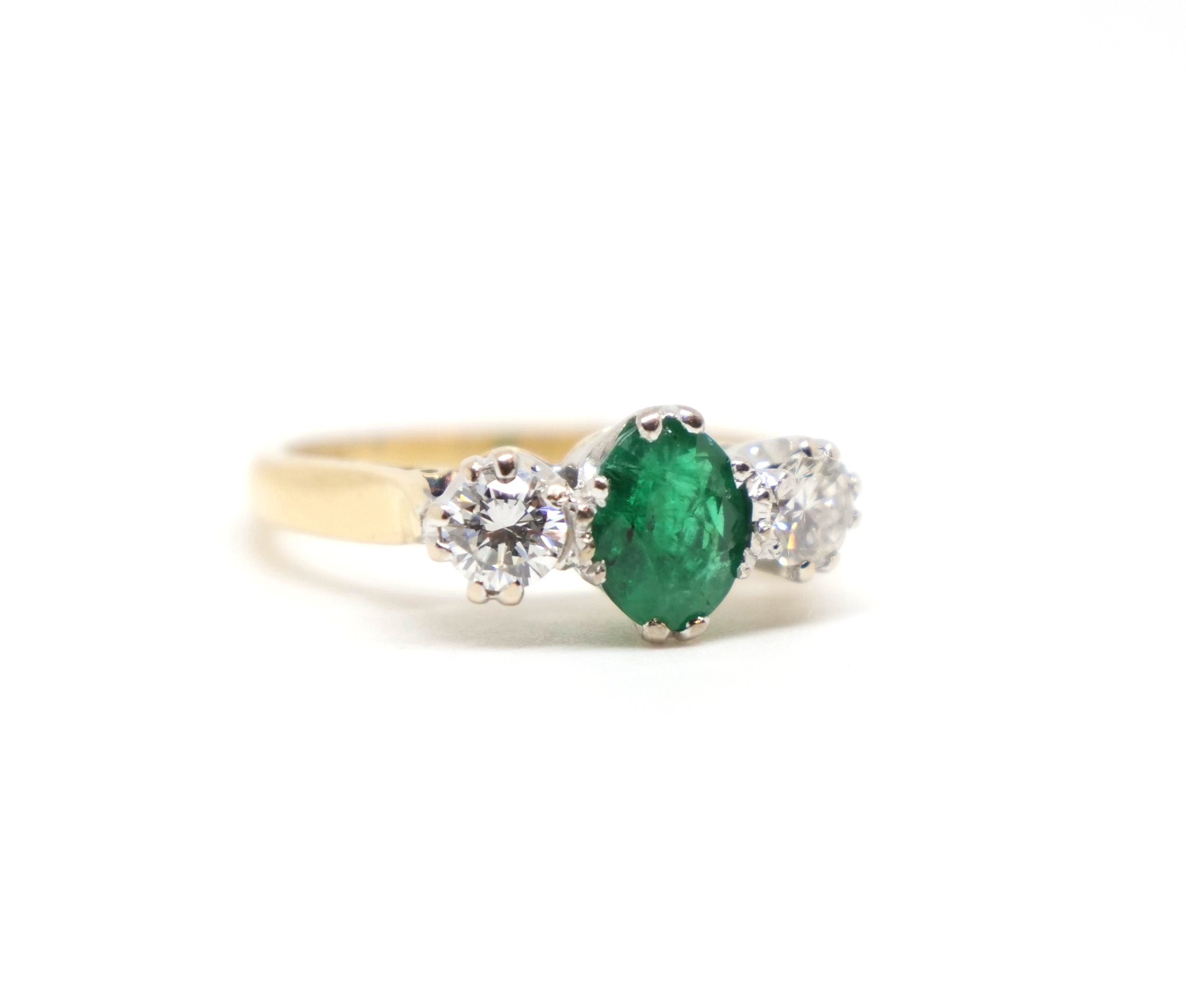 Super vintage emerald and diamond trilogy ring, set with a central oval cut emerald with a brilliant cut diamond to each side. All set in 18ct gold.