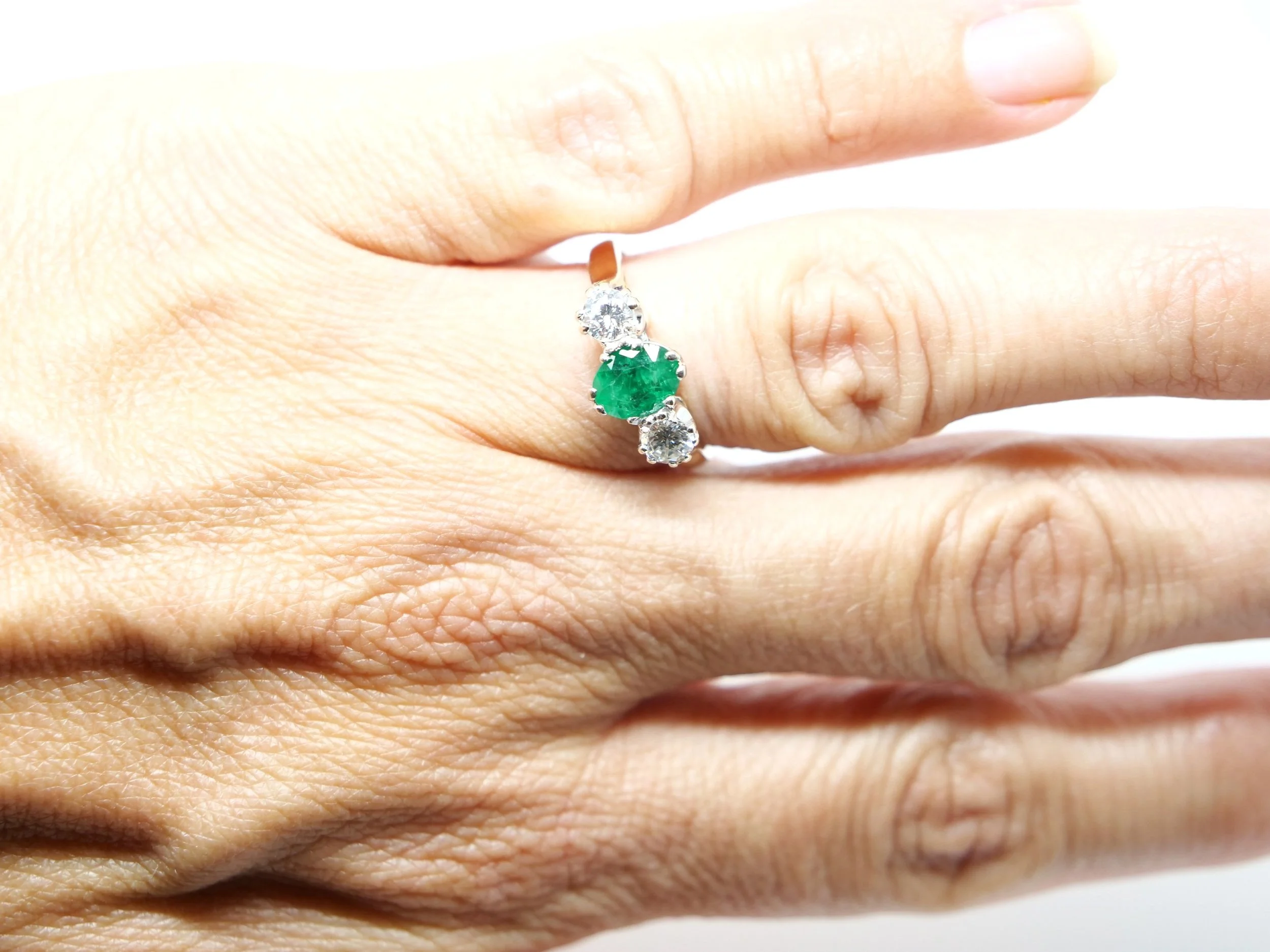 Super vintage emerald and diamond trilogy ring, set with a central oval cut emerald with a brilliant cut diamond to each side. All set in 18ct gold.