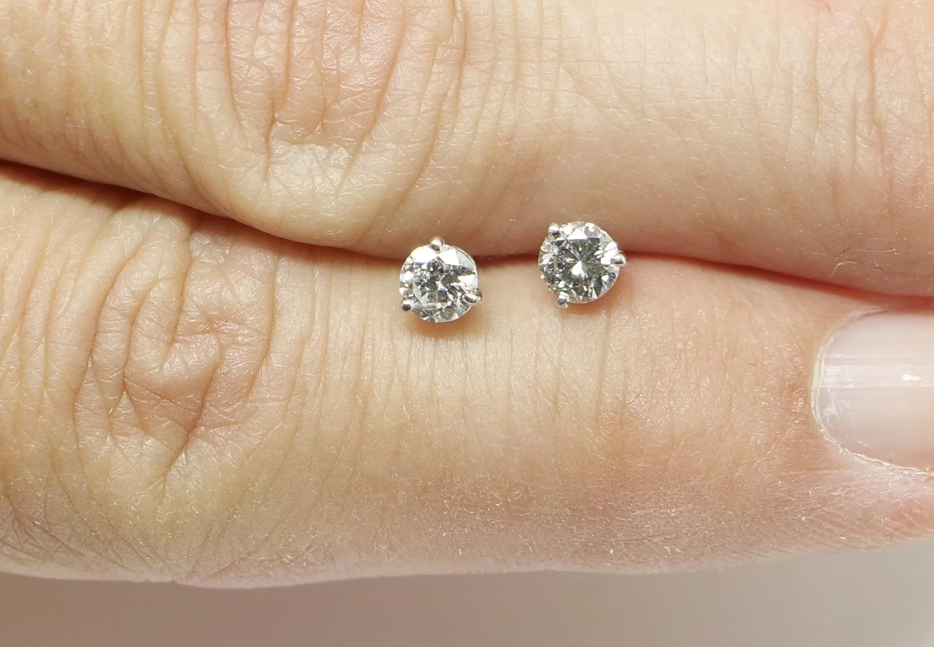 Stunning sparkly diamond stud earrings, each set with a lively 0.25ct brilliant cut diamond (0.5ct total). Classic three prong setting in 18ct white gold. With 18ct white gold butterfly backs.