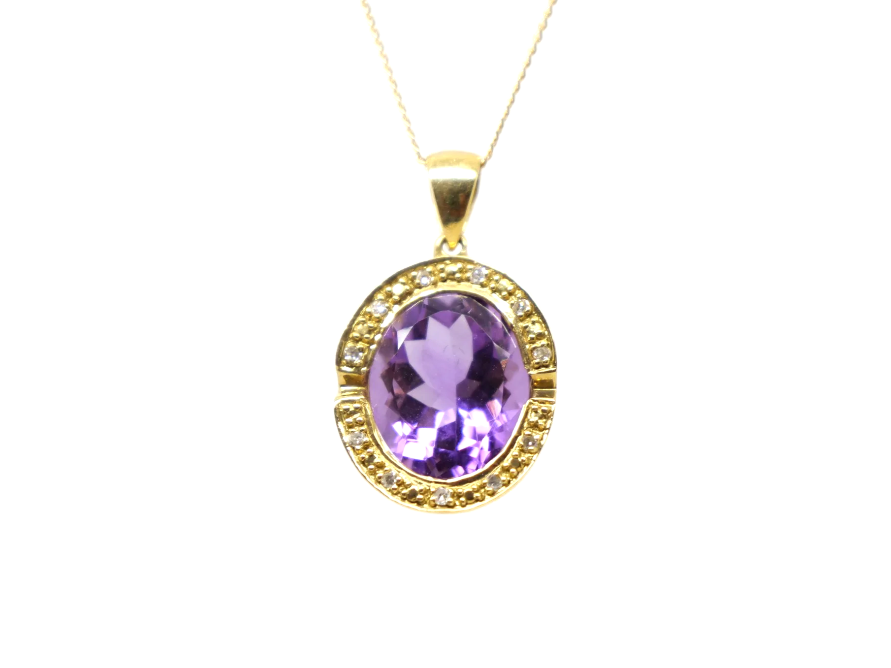 An 18ct gold pendant necklace with a large oval amethyst of approximately 4.5ct in a diamond-set halo.