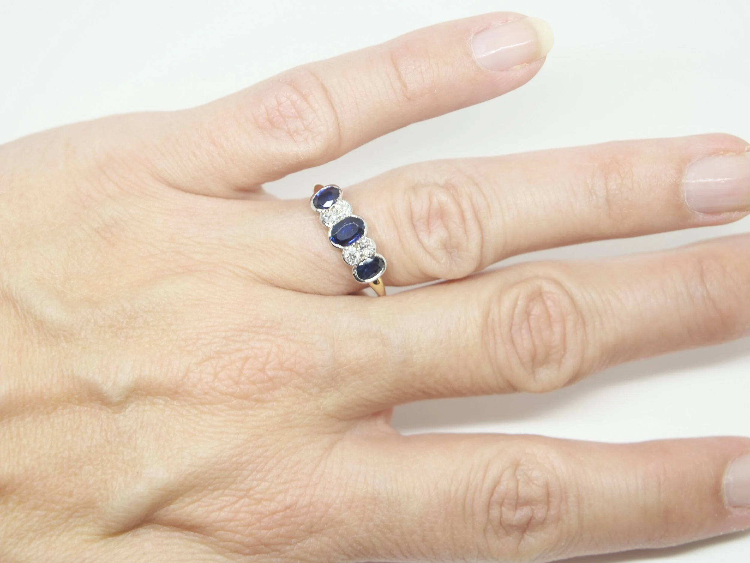 Superb Art Deco sapphire and diamond ring, set with three oval cut sapphires and four diamonds. Set in 18ct gold and platinum.