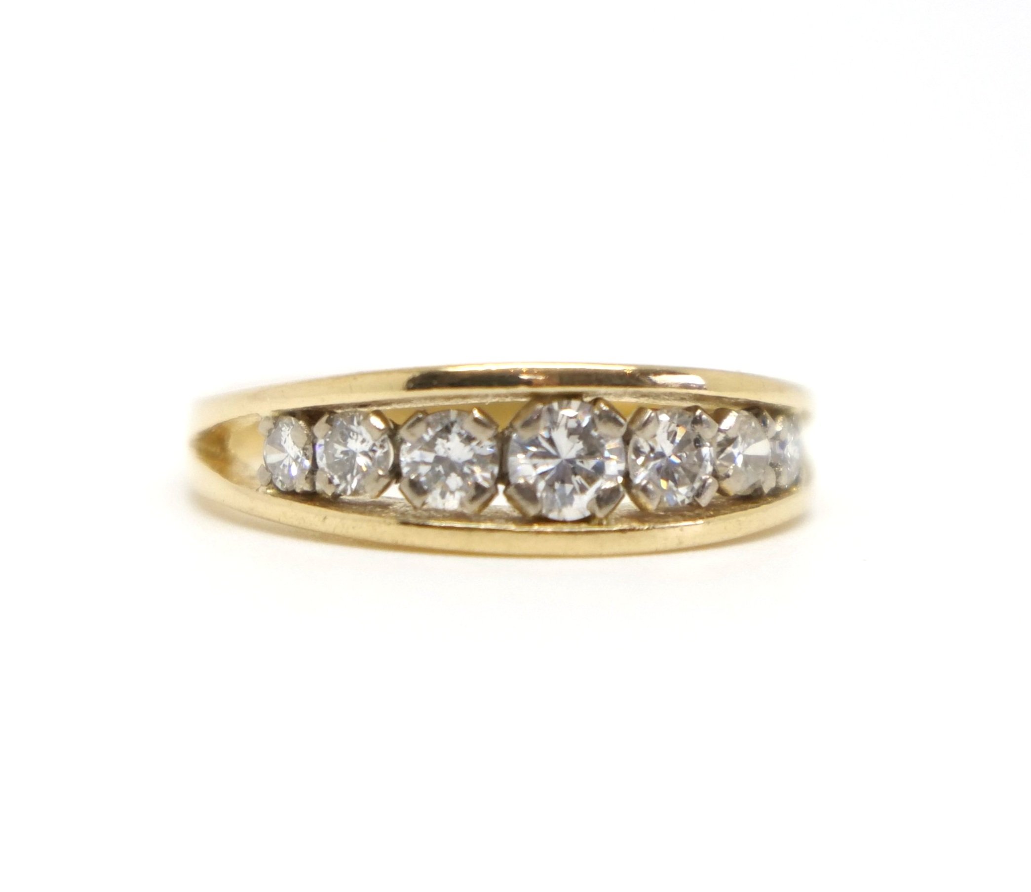 Lovely vintage ring, set with seven graduated brilliant cut diamonds in this channel style setting. Approximately 0.5cts of diamonds overall in this 18ct gold ring.