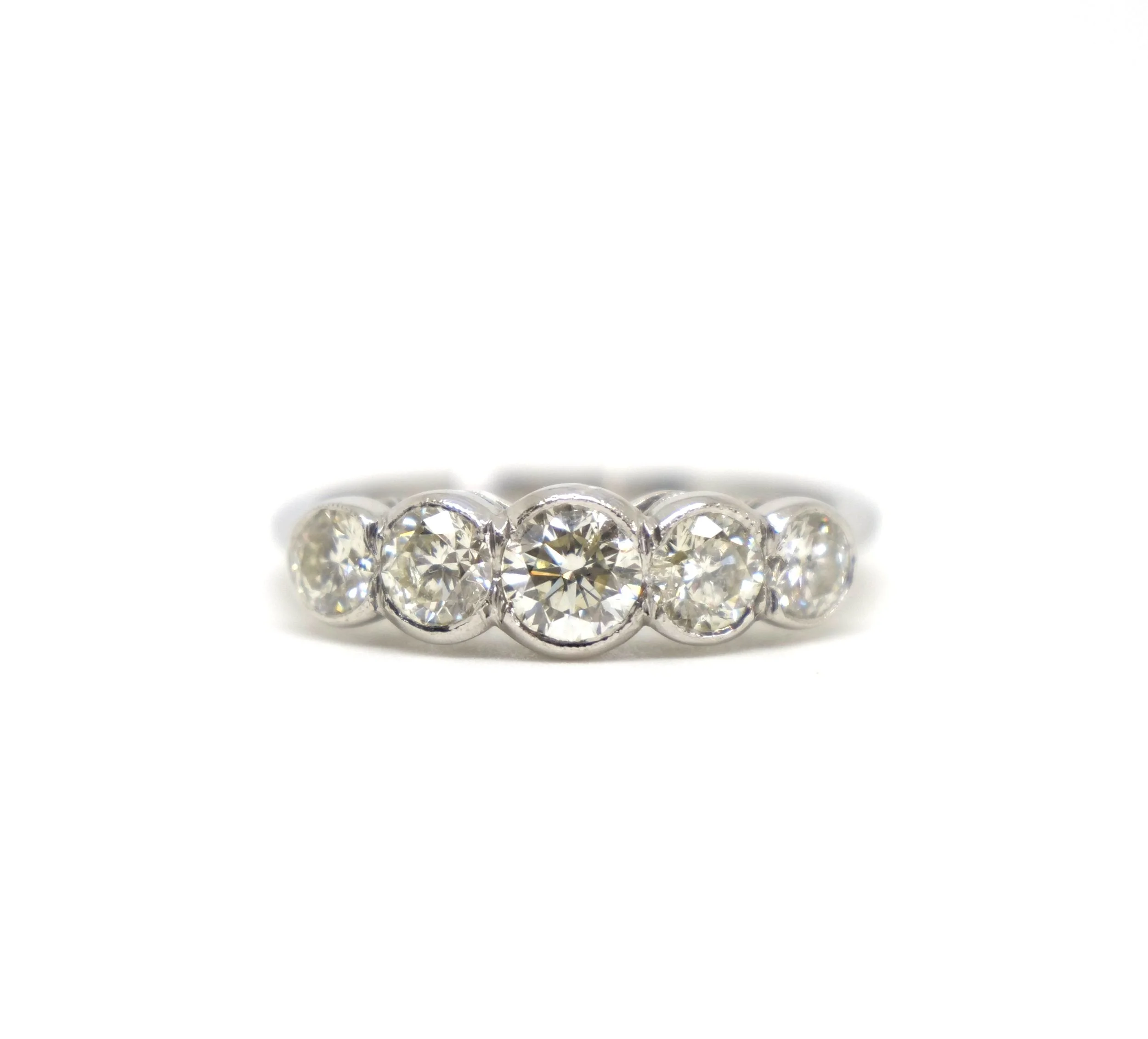 Gorgeous vintage semi-bezel set graduated five stone diamond ring. Set in platinum, with approximately 1.7cts of lovely sparkly diamonds.