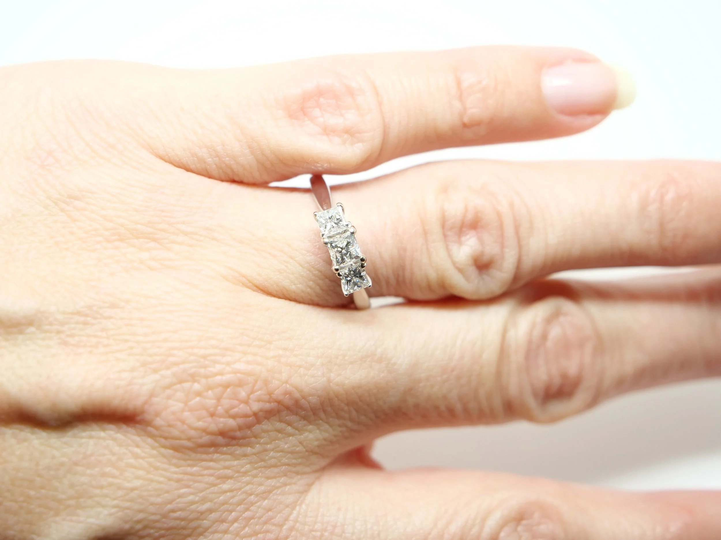 Very elegant contemporary 18ct diamond trilogy ring, set with three very sparkly princess cut diamonds. In a traditional graduated setting, the total weight of the diamonds is 0.75ct.