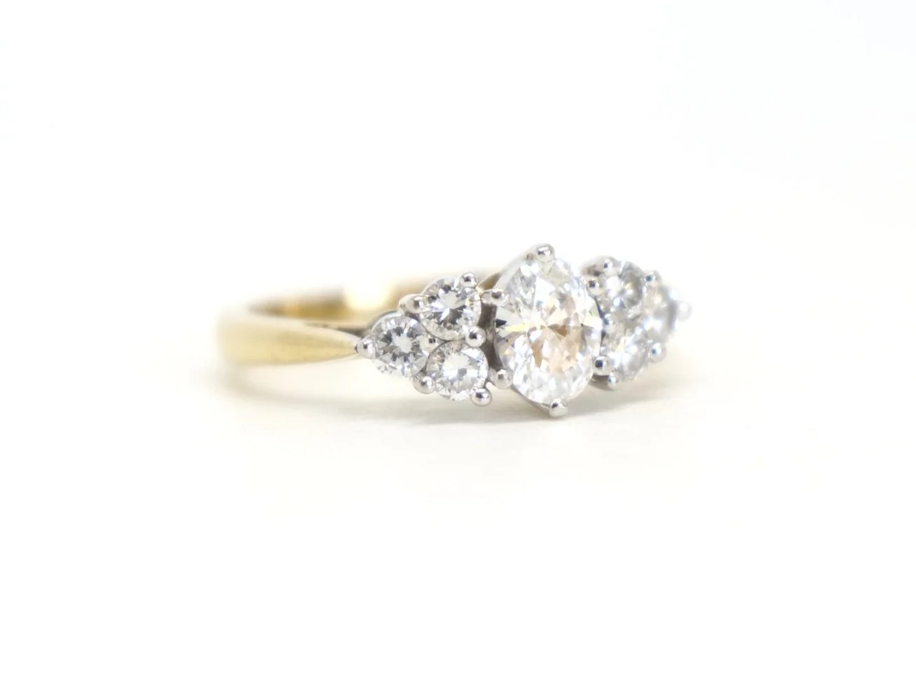 Stunning 18ct gold seven stone diamond ring, set with a superb oval cut diamond, with three round brilliant cut diamonds to each side. All diamonds are E/F colour and VVS clarity.