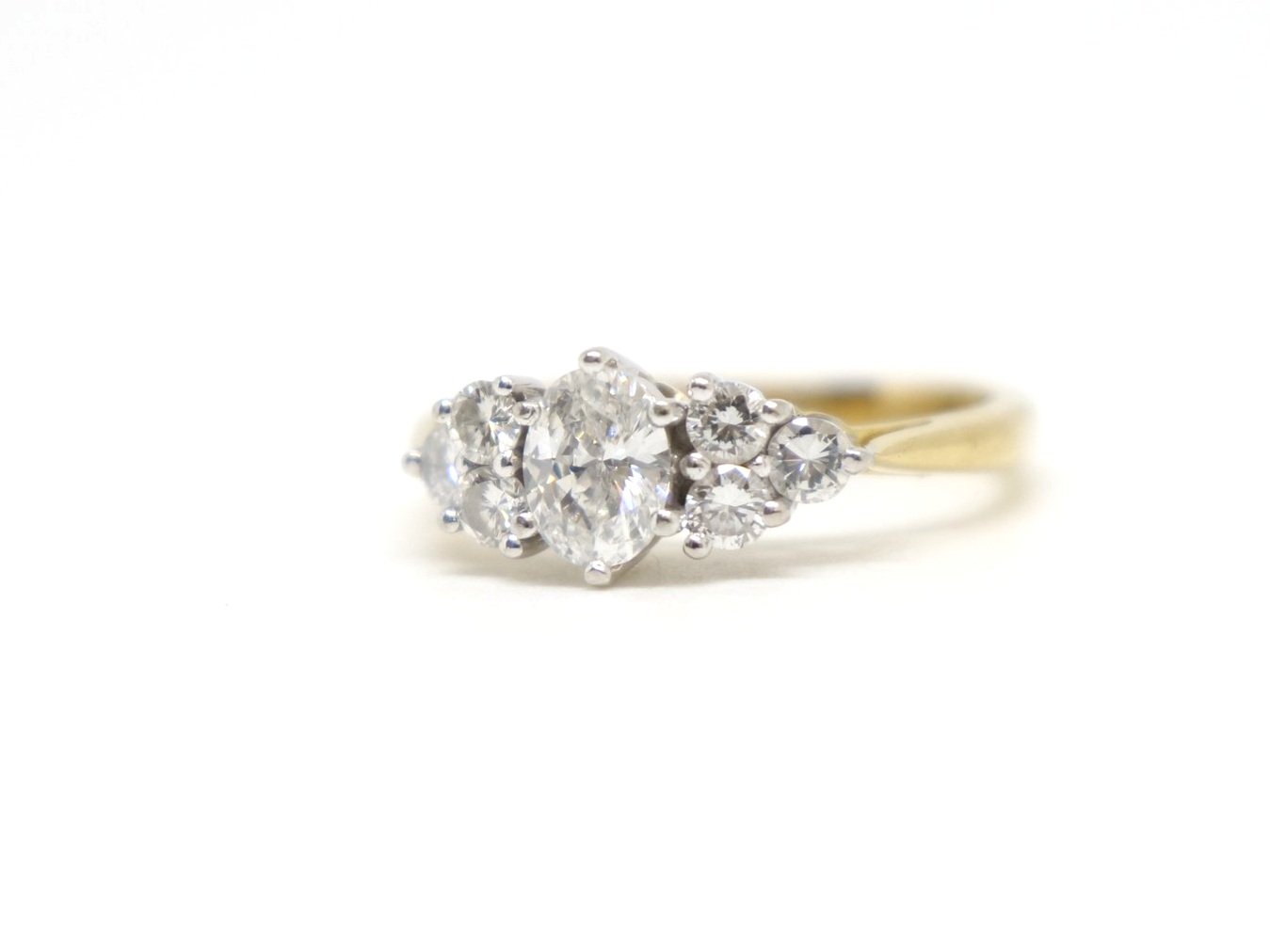Stunning 18ct gold seven stone diamond ring, set with a superb oval cut diamond, with three round brilliant cut diamonds to each side. All diamonds are E/F colour and VVS clarity.