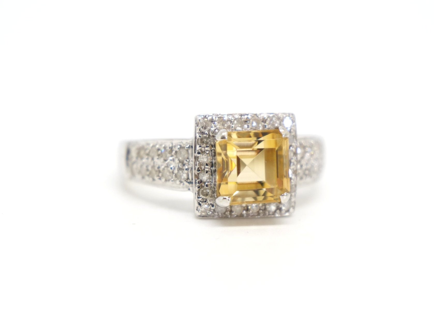 Super 14ct white gold citrine and diamond cocktail ring, set with a square cut citrine and surrounded by diamonds. A double row of diamonds to each shoulder.