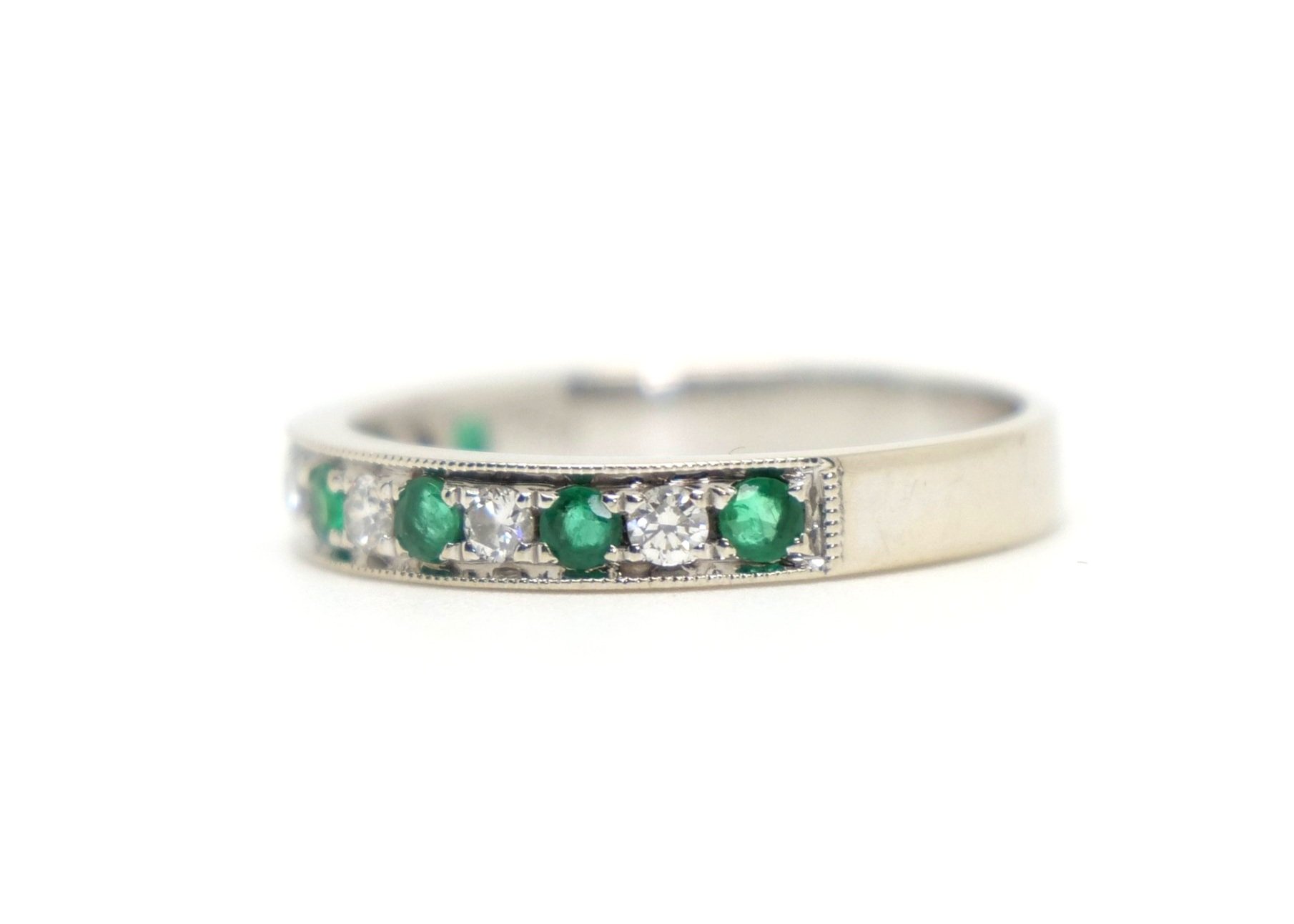 Very pretty 18ct white gold half eternity ring, set with round cut emeralds and diamonds. Lovely milgrain edging to top and bottom.